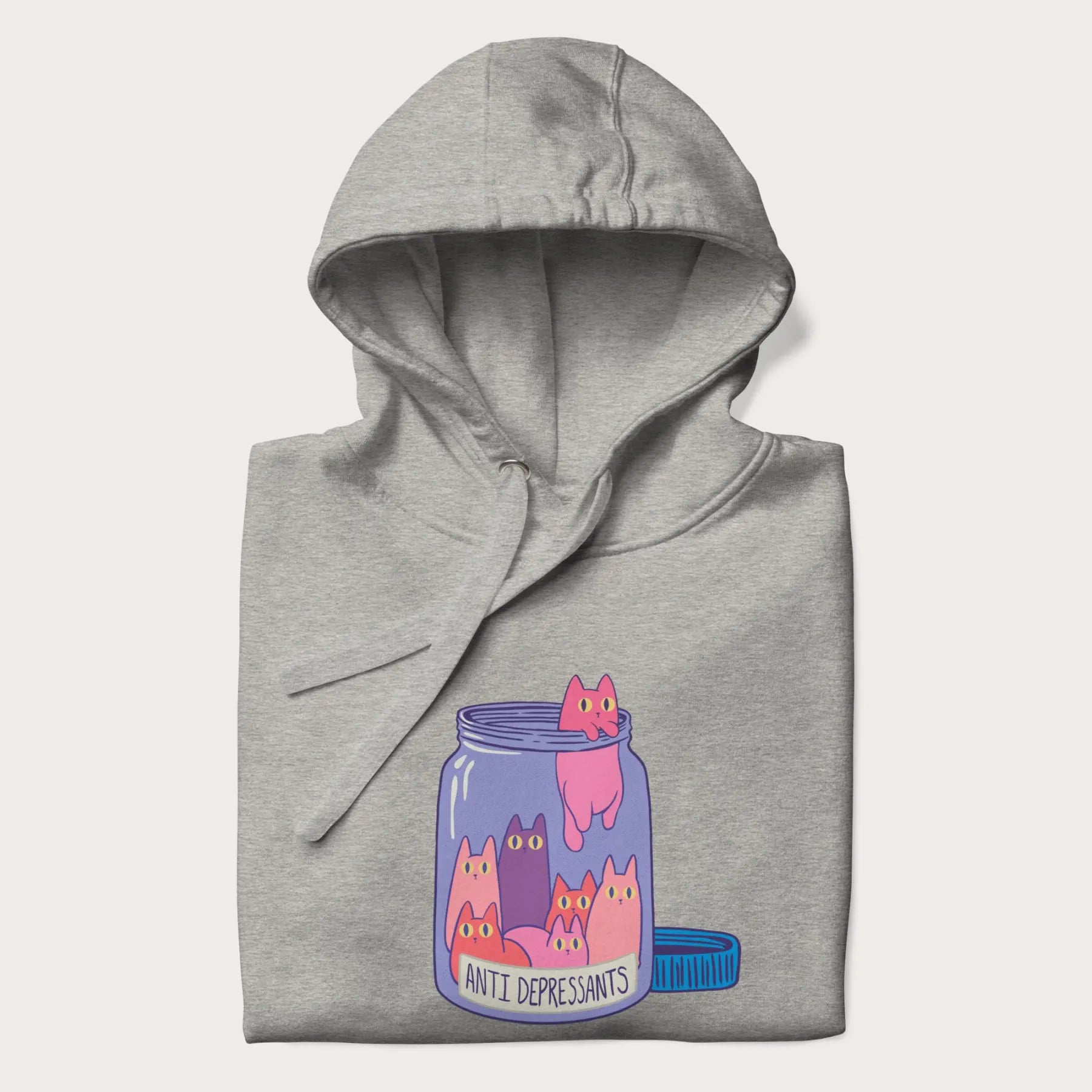 Cartoon cats in a clear jar labeled 'Anti Depressants' printed on a folded light grey hoodie.