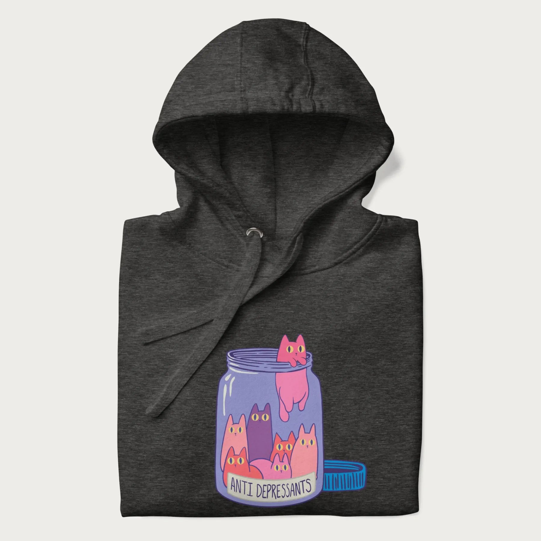 Cartoon cats in a clear jar labeled 'Anti Depressants' printed on a folded dark grey hoodie.