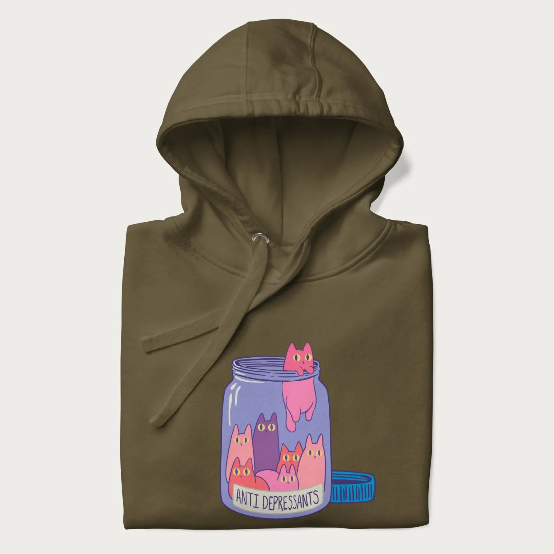 Cartoon cats in a clear jar labeled 'Anti Depressants' printed on a folded military green hoodie.
