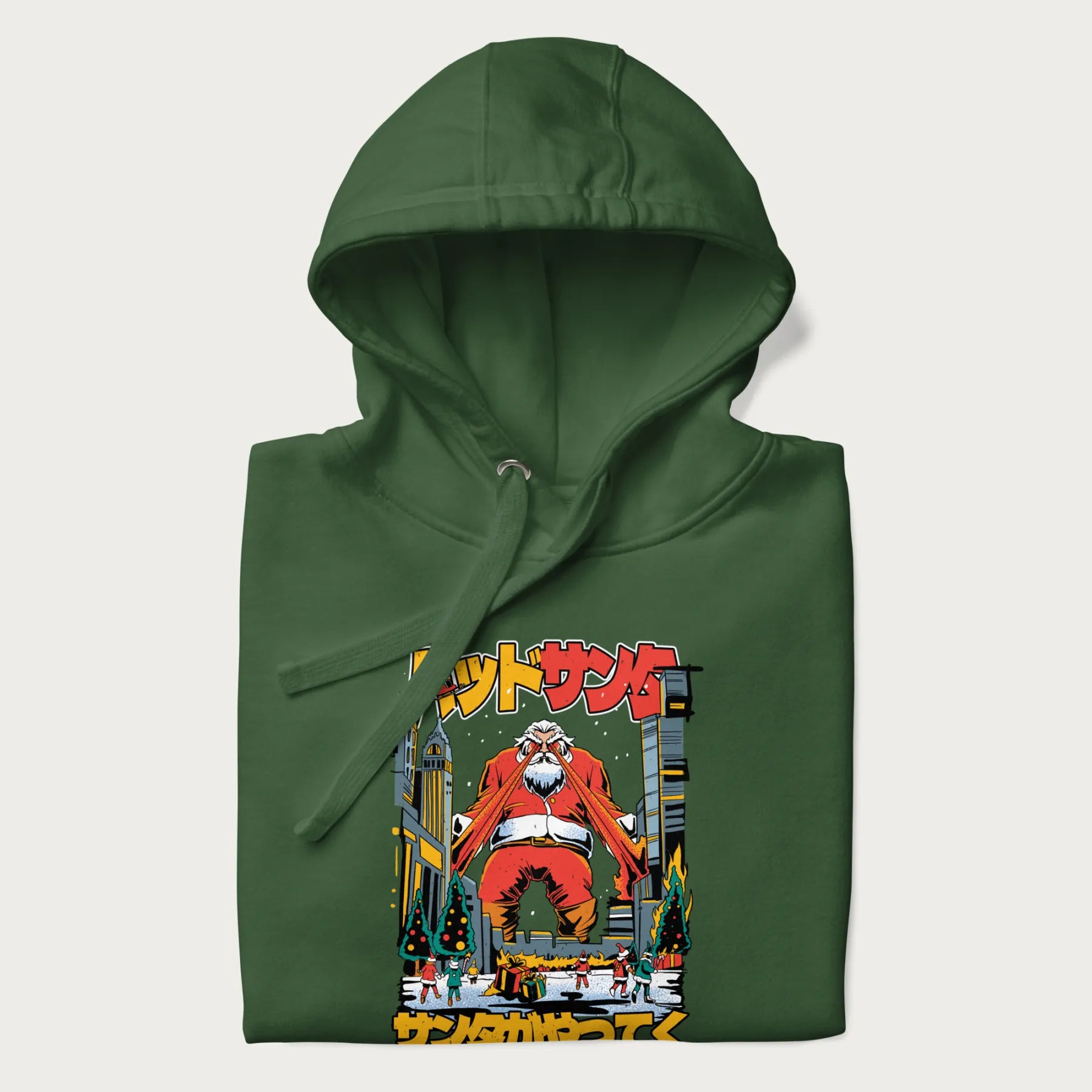 Folded forest green hoodie with Japanese graphic of Santa Claus with laser eyes attacking a festive city, with the Japanese text 'パッドサンタ' (Bad Santa).