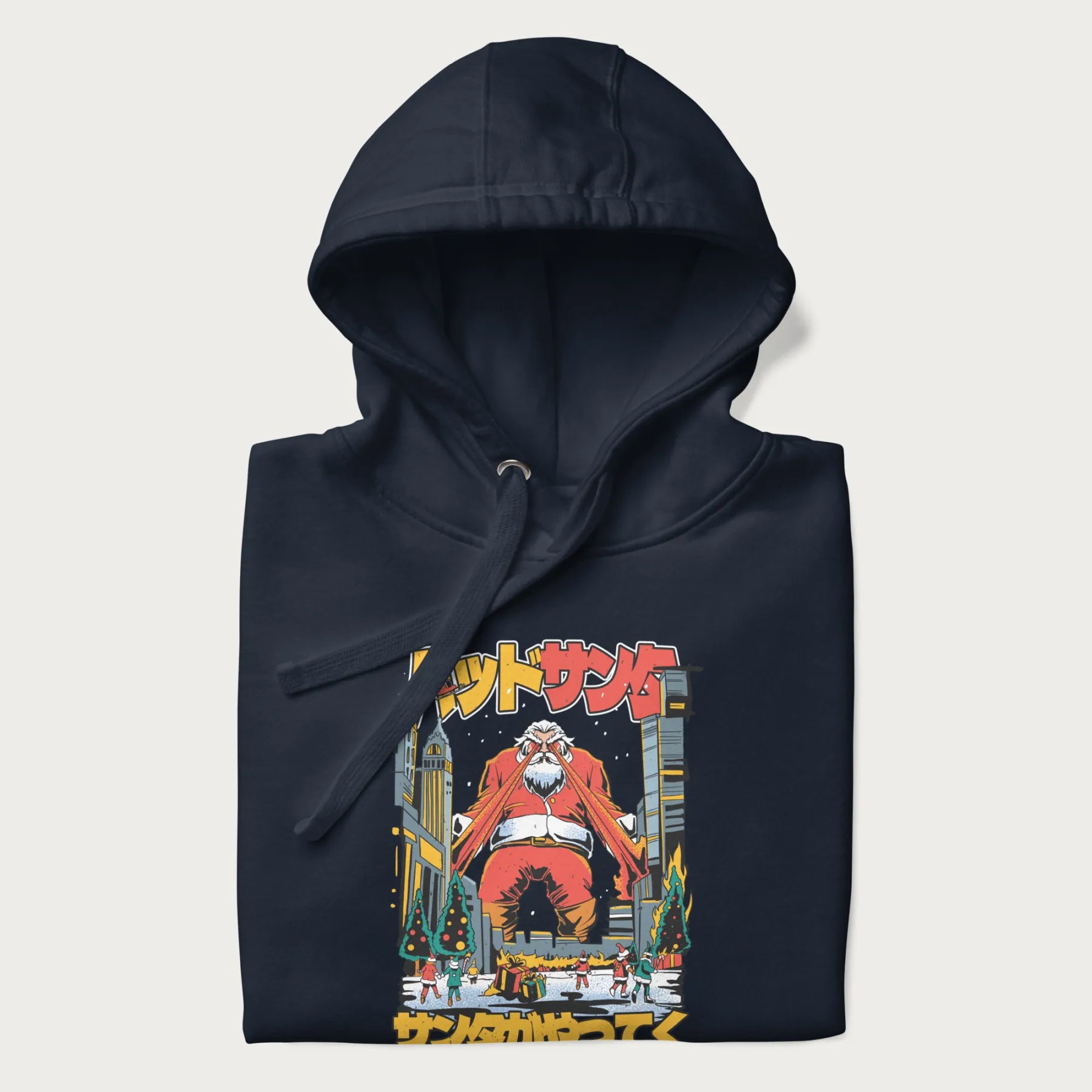 Folded navy blue hoodie with Japanese graphic of Santa Claus with laser eyes attacking a festive city, with the Japanese text 'パッドサンタ' (Bad Santa).