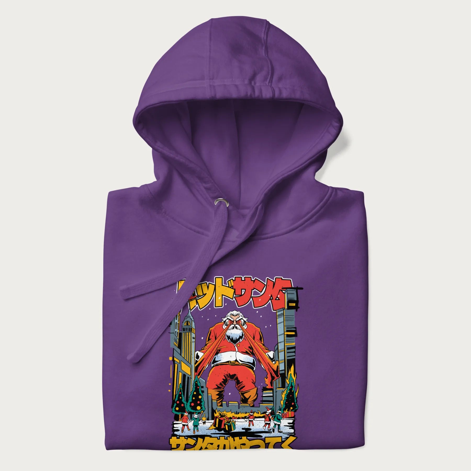 Folded purple hoodie with Japanese graphic of Santa Claus with laser eyes attacking a festive city, with the Japanese text 'パッドサンタ' (Bad Santa).