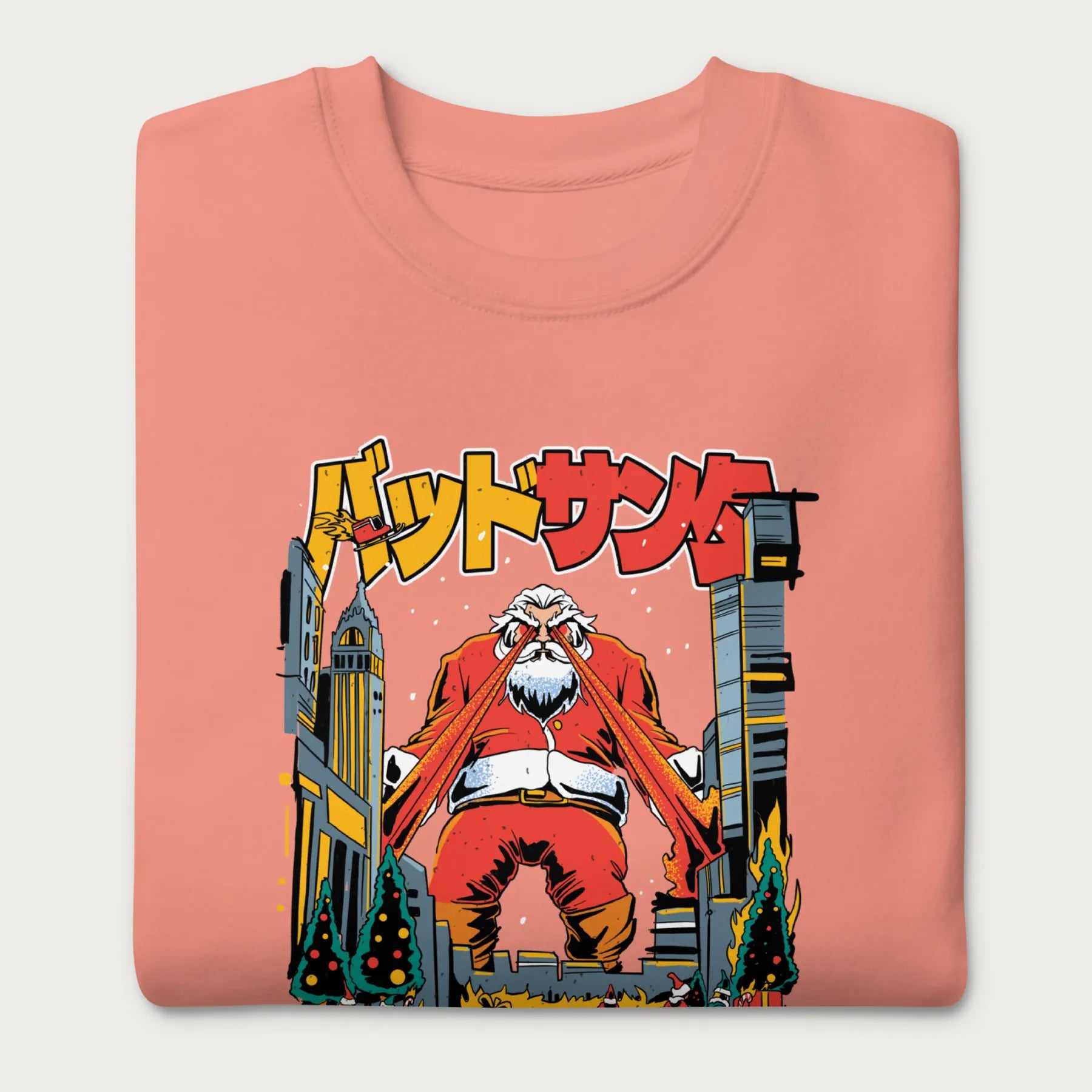 Folded light pink sweatshirt with a bold graphic of Santa Claus with laser eyes attacking a city, featuring bold Japanese text.