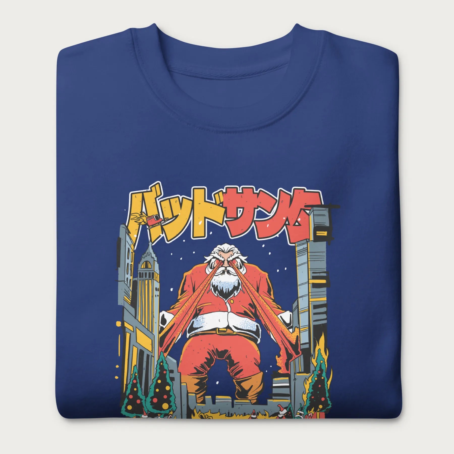 Folded royal blue sweatshirt with a bold graphic of Santa Claus with laser eyes attacking a city, featuring bold Japanese text.