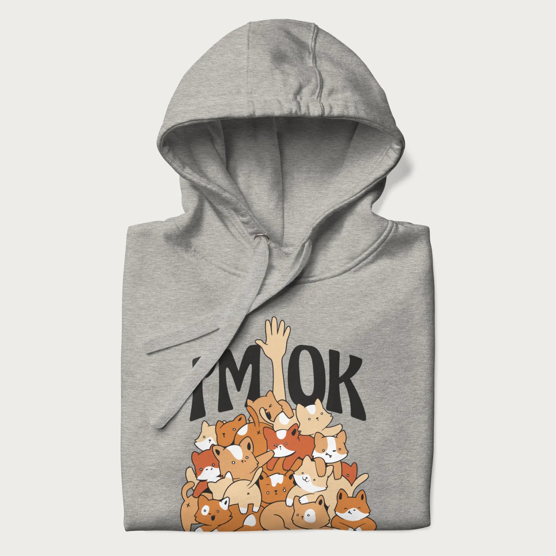 Folded light grey hoodie with a graphic of kittens piled on top of a person with "I'M OK" in large letters.