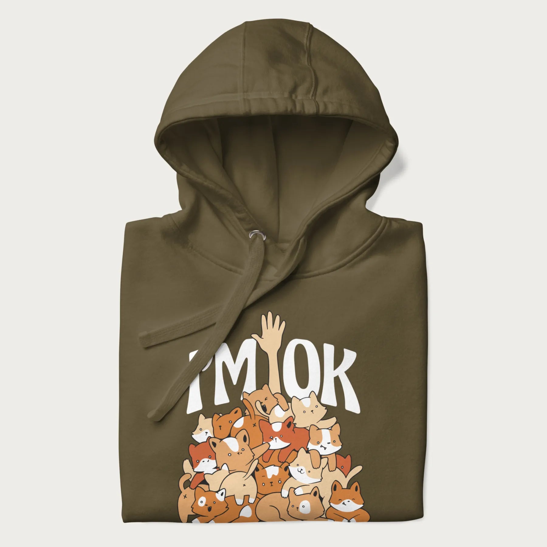 Folded military green hoodie with a graphic of kittens piled on top of a person with "I'M OK" in large letters.