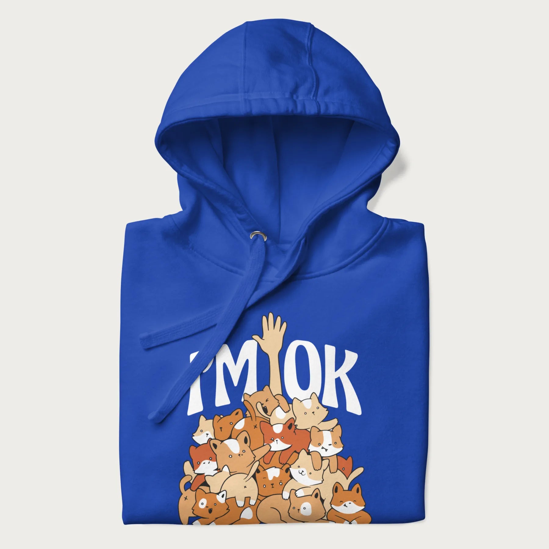 Folded royal blue hoodie with a graphic of kittens piled on top of a person with "I'M OK" in large letters.