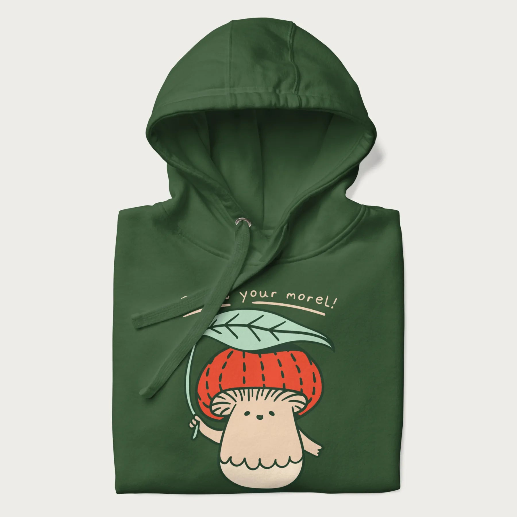 Folded forest green hoodie with a graphic of an adorable mushroom character with a red cap and the text 'Boost your morel!'.