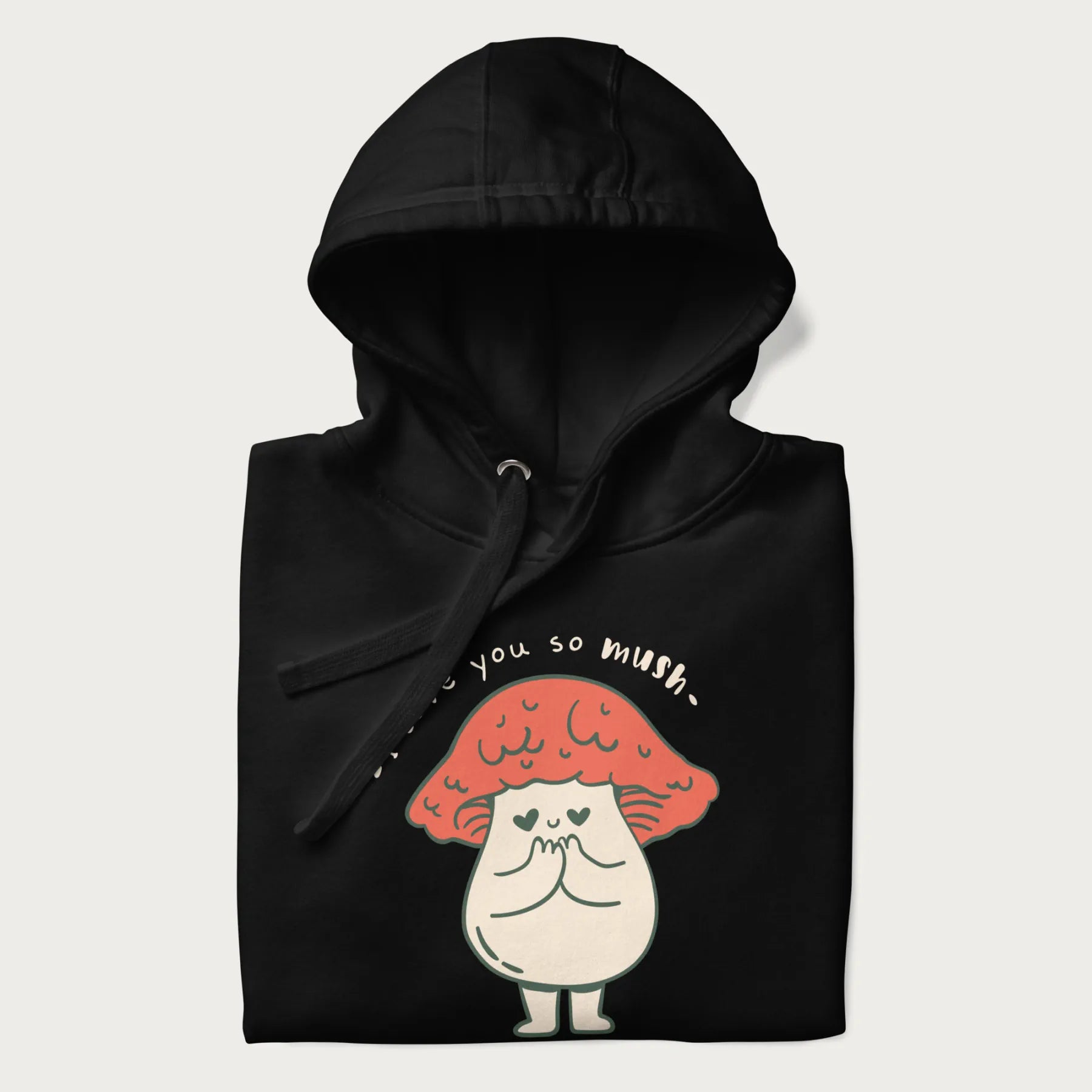 Folded black hoodie with a graphic of a cute mushroom character with a red cap and heart-shaped eyes, and the text 'I Love You So Mush'.