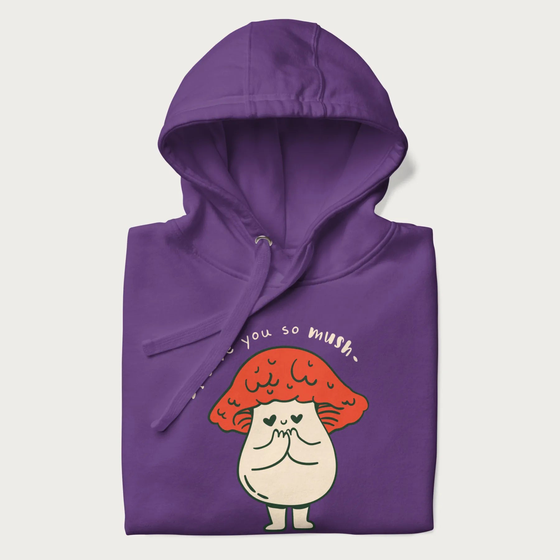 Folded purple hoodie with a graphic of a cute mushroom character with a red cap and heart-shaped eyes, and the text 'I Love You So Mush'.