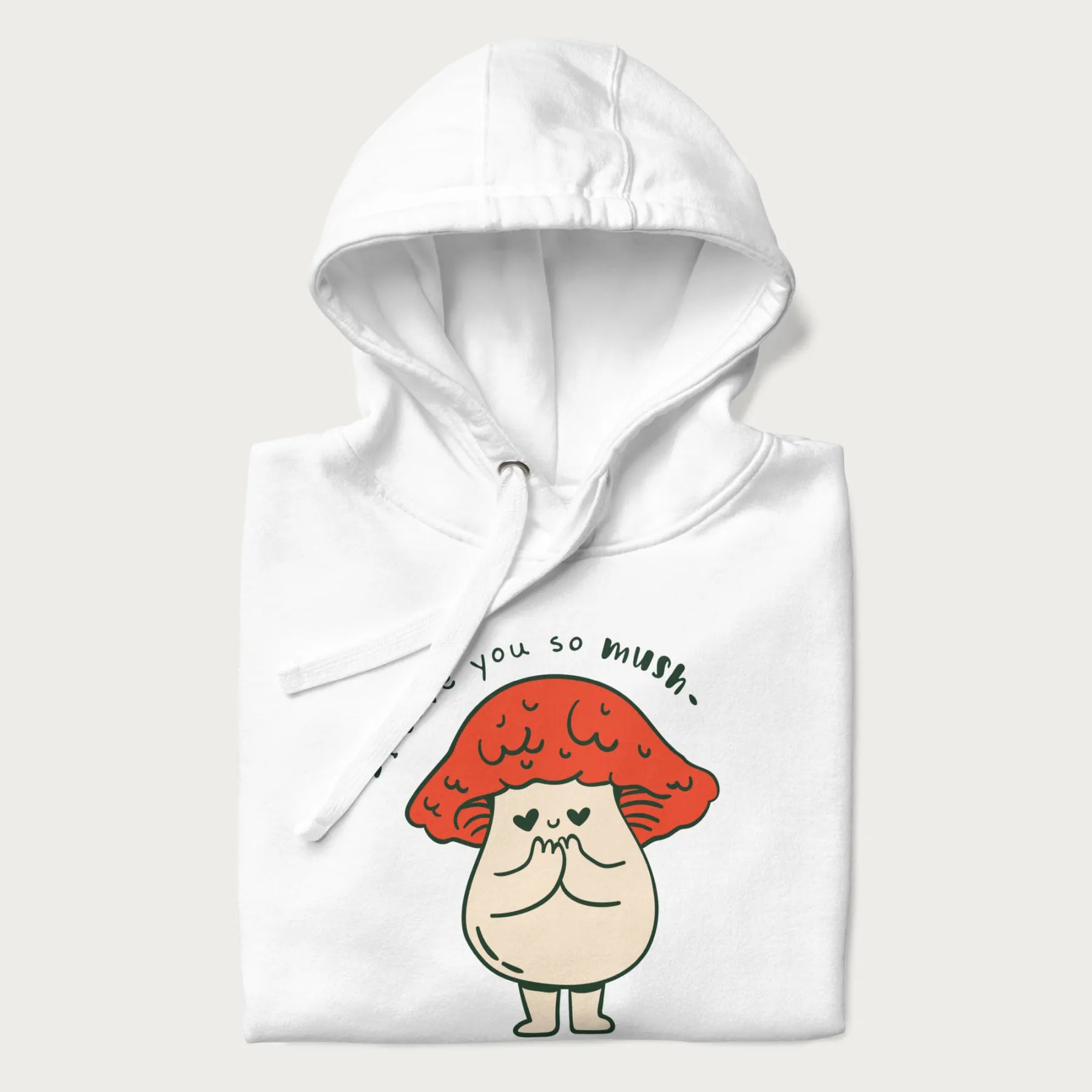 Folded white hoodie with a graphic of a cute mushroom character with a red cap and heart-shaped eyes, and the text 'I Love You So Mush'.