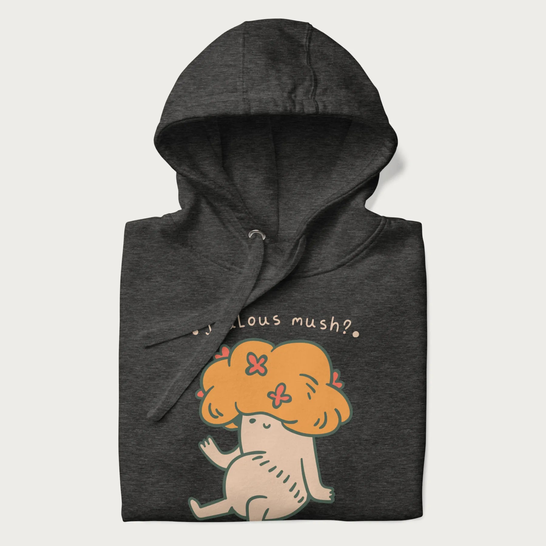 Folded dark grey hoodie with a graphic of a mushroom character with an orange cap and the text 'Jealous mush?'.