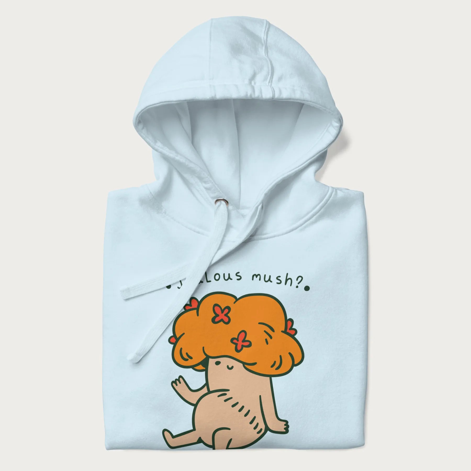 Folded light blue hoodie with a graphic of a mushroom character with an orange cap and the text 'Jealous mush?'.