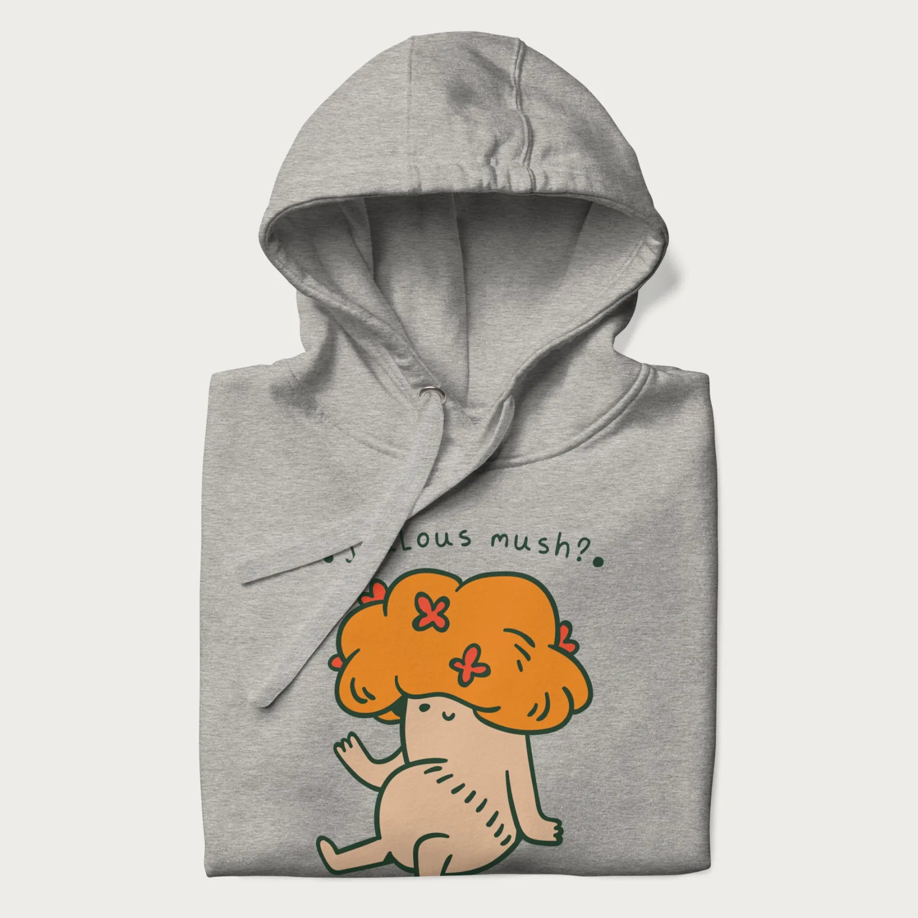 Folded light grey hoodie with a graphic of a mushroom character with an orange cap and the text 'Jealous mush?'.
