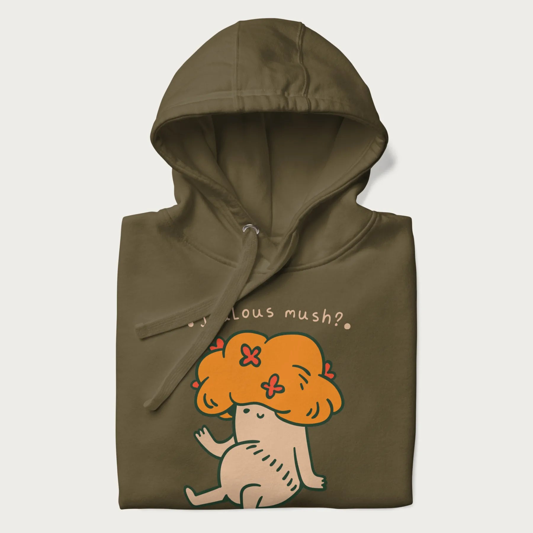 Folded military green hoodie with a graphic of a mushroom character with an orange cap and the text 'Jealous mush?'.