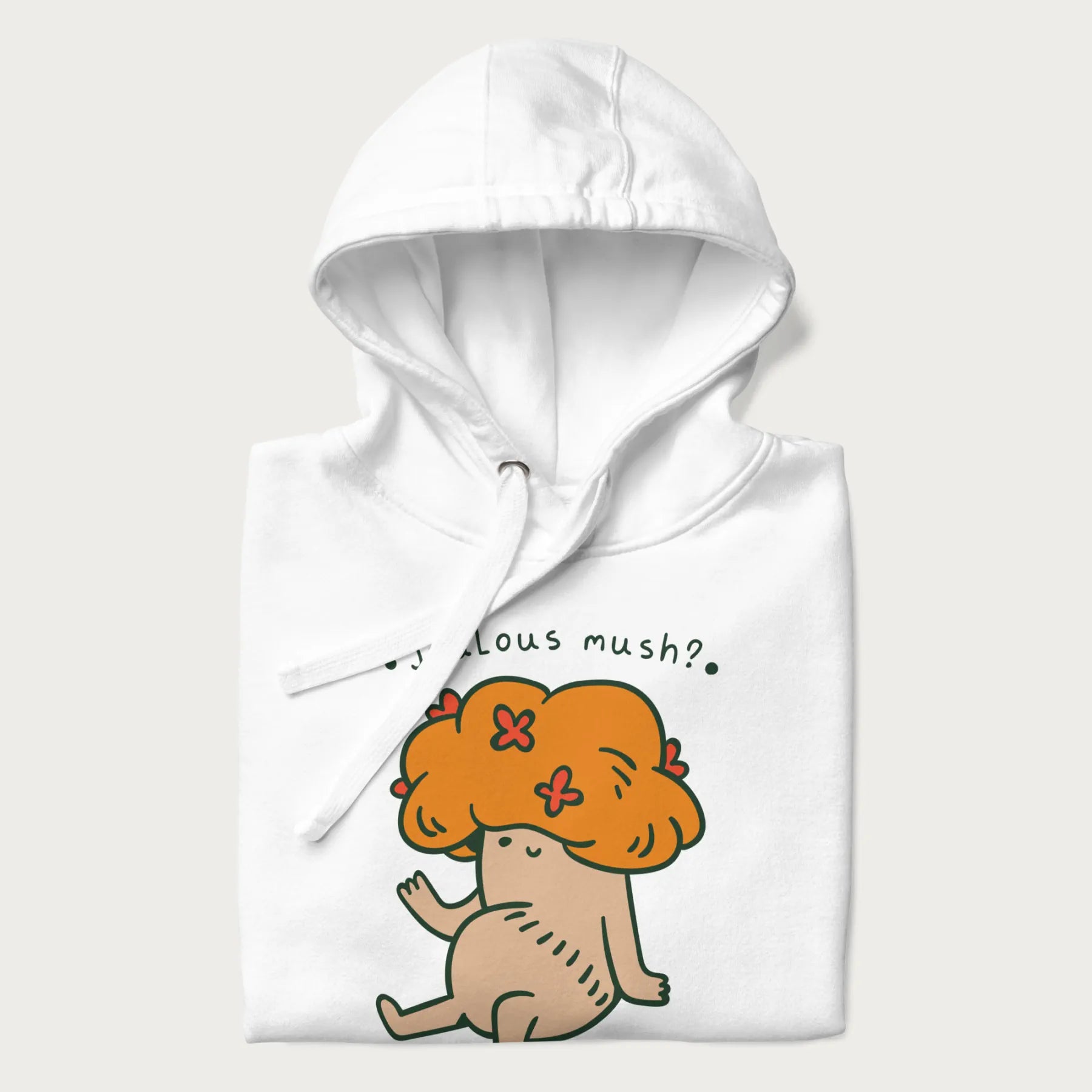 Folded white hoodie with a graphic of a mushroom character with an orange cap and the text 'Jealous mush?'.