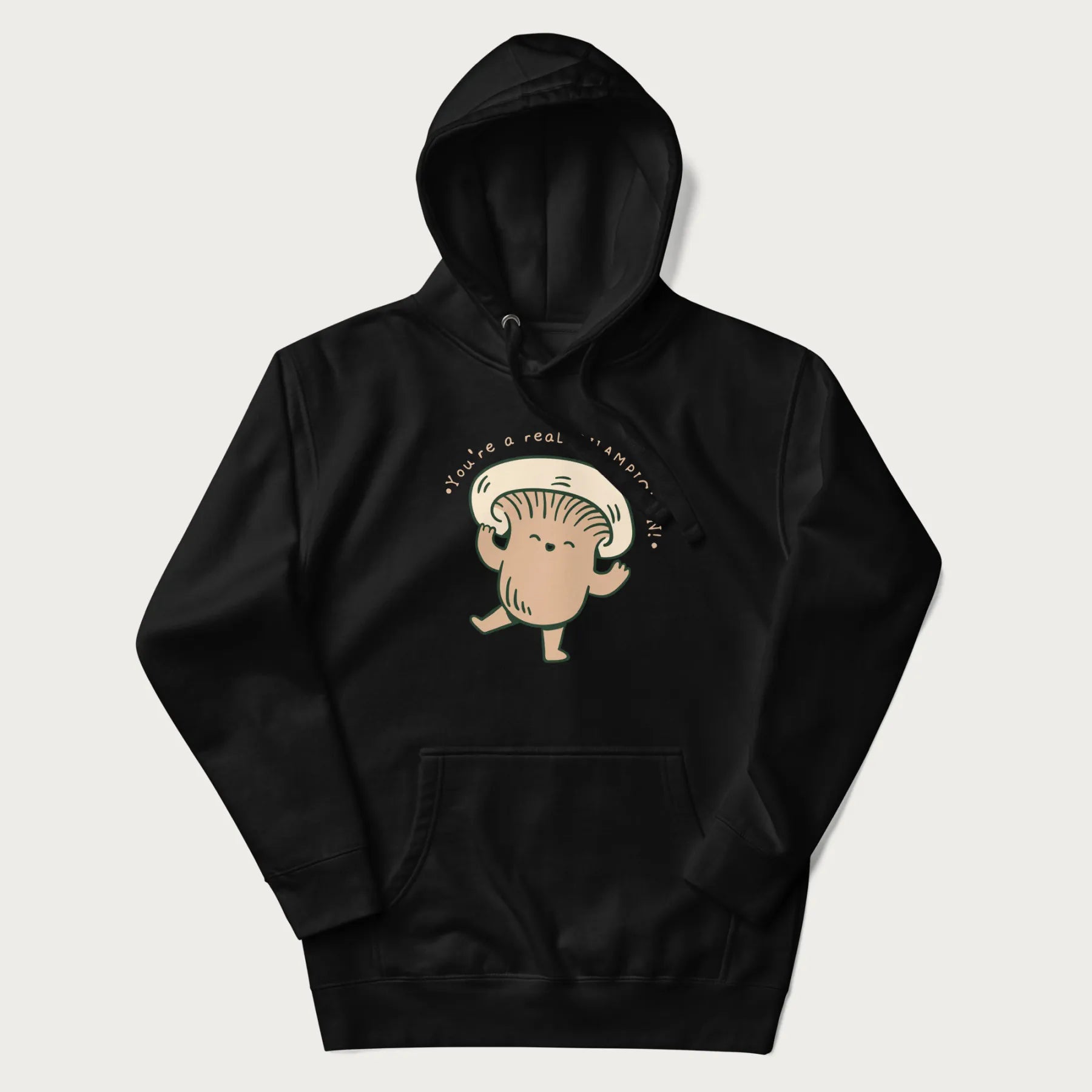 Black hoodie with a graphic of an adorable mushroom character and the text 'You're a real CHAMPIGNON!'.