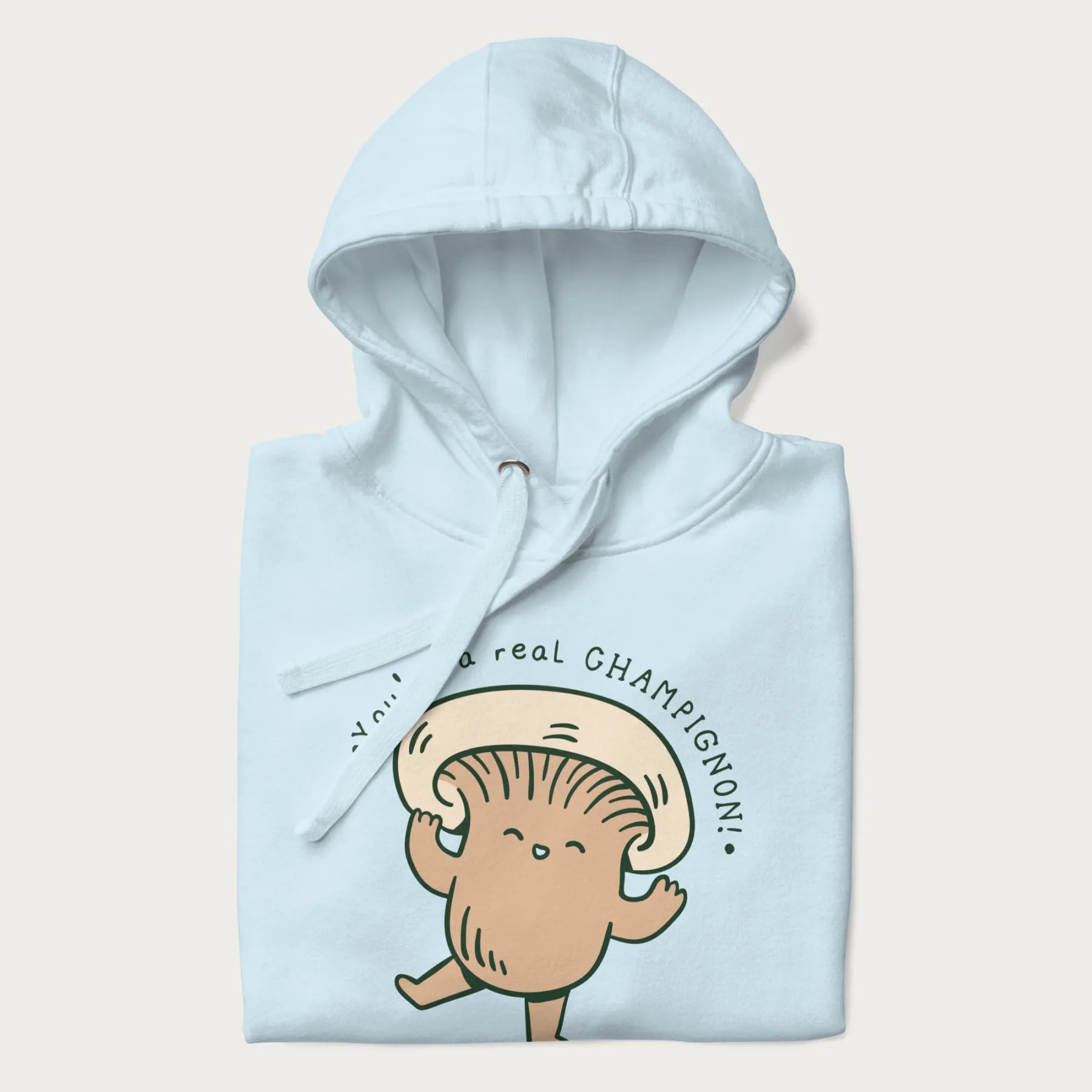 Folded light blue hoodie with a graphic of an adorable mushroom character and the text 'You're a real CHAMPIGNON!'.