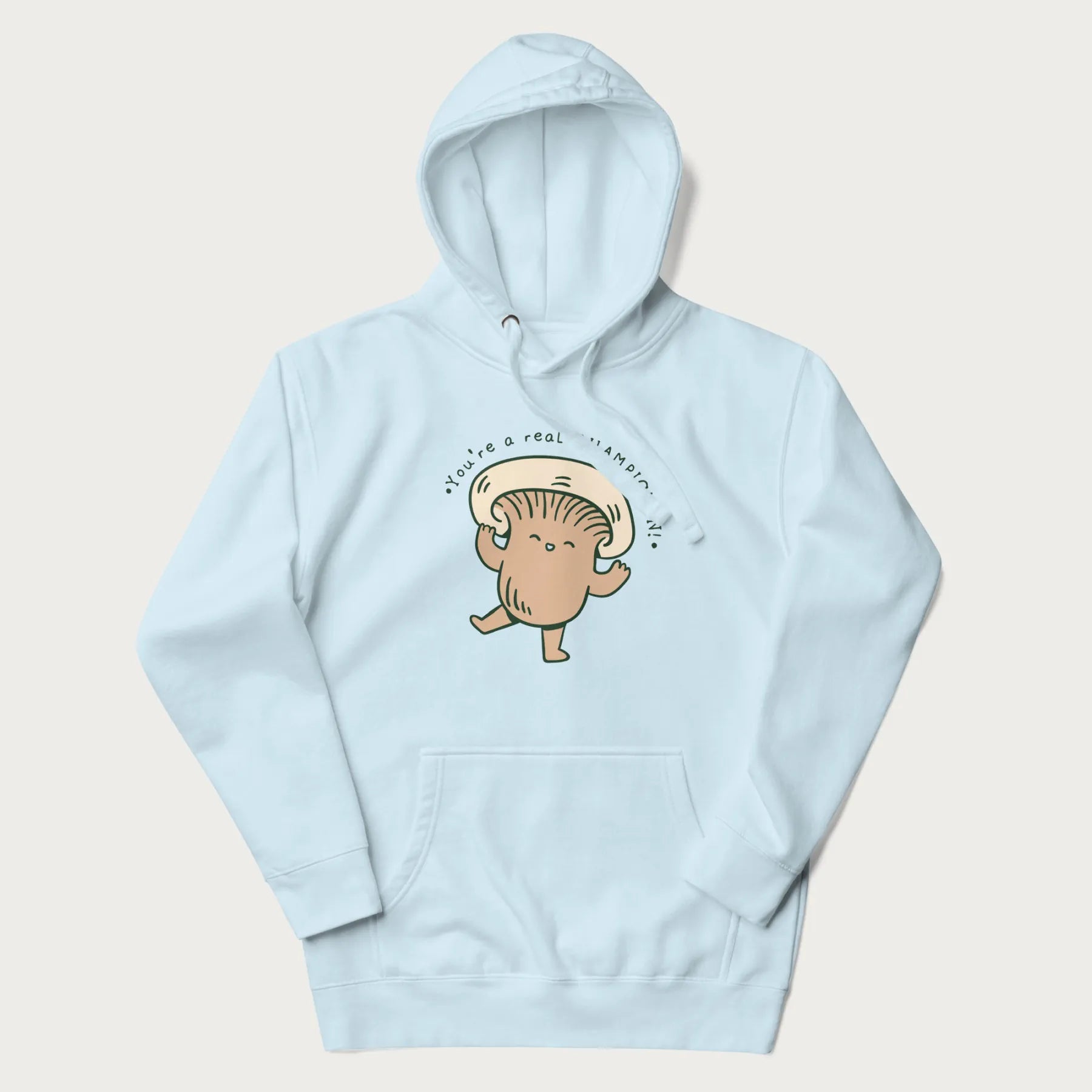 Light blue hoodie with a graphic of an adorable mushroom character and the text 'You're a real CHAMPIGNON!'.