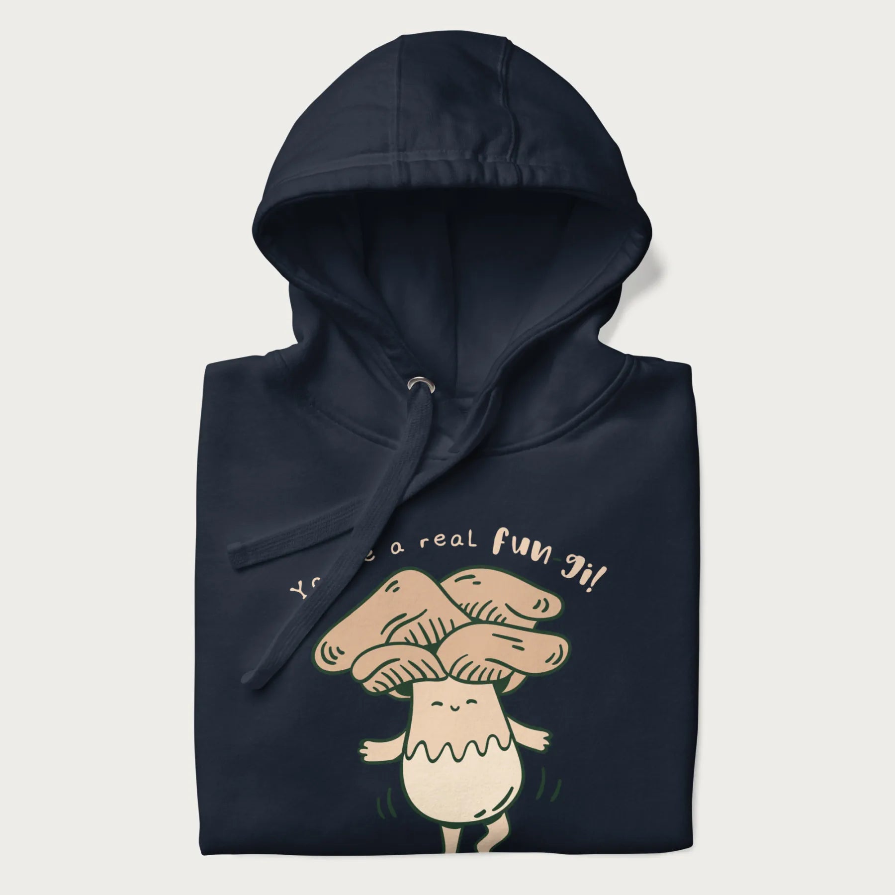 Folded navy blue hoodie with a graphic of a happy mushroom character and the text 'You're a real fun-gi!'.