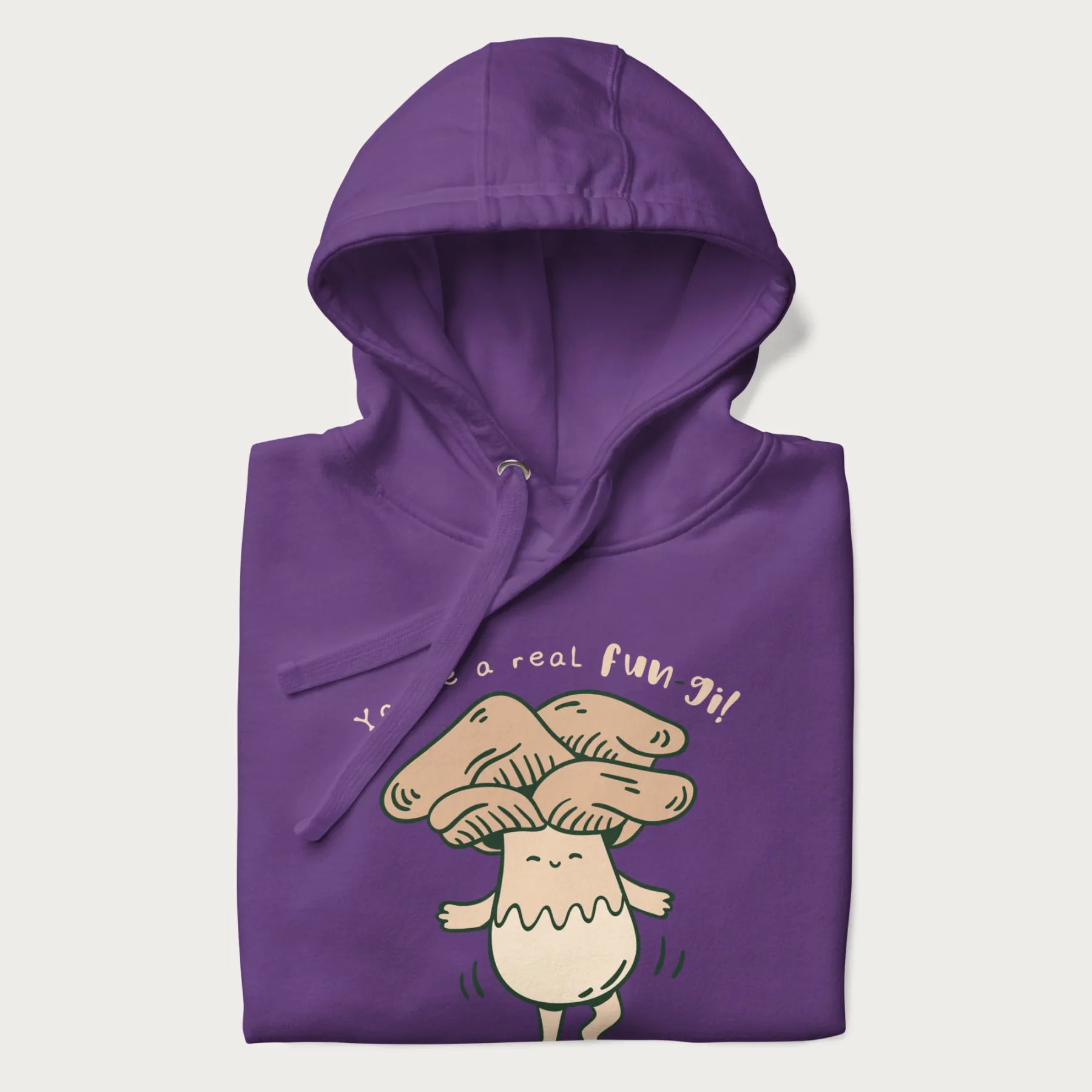 Folded purple hoodie with a graphic of a happy mushroom character and the text 'You're a real fun-gi!'.