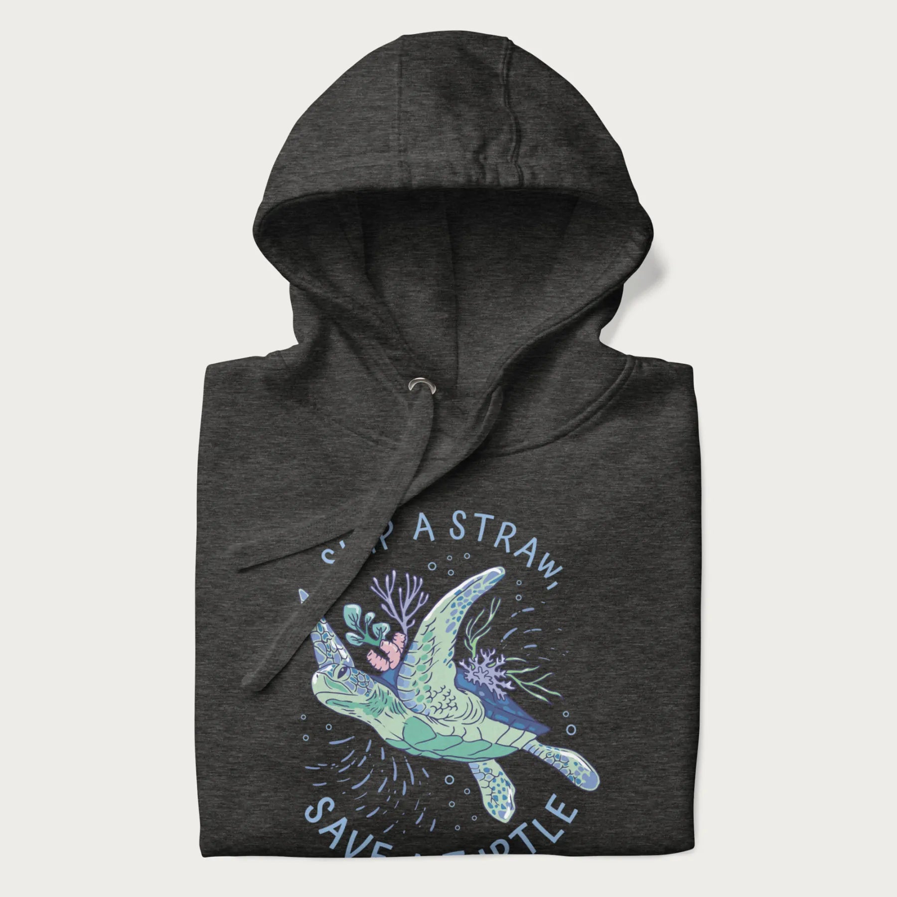 Folded dark grey hoodie with a graphic of a sea turtle with coral on it's shell and the text 'Skip a Straw, Save a Turtle'.