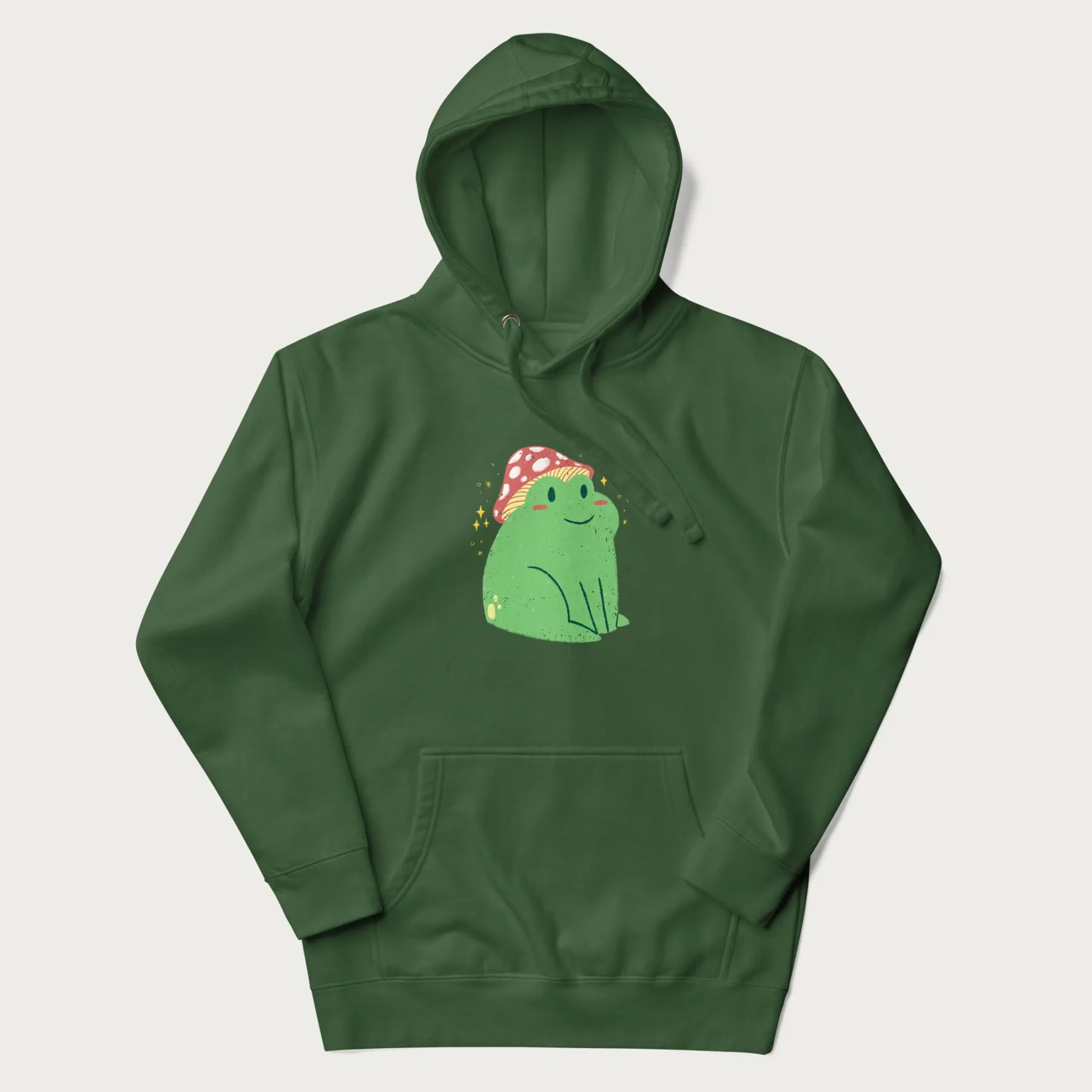 Forest green hoodie with a graphic of a green frog wearing a mushroom cap surrounded by stars.
