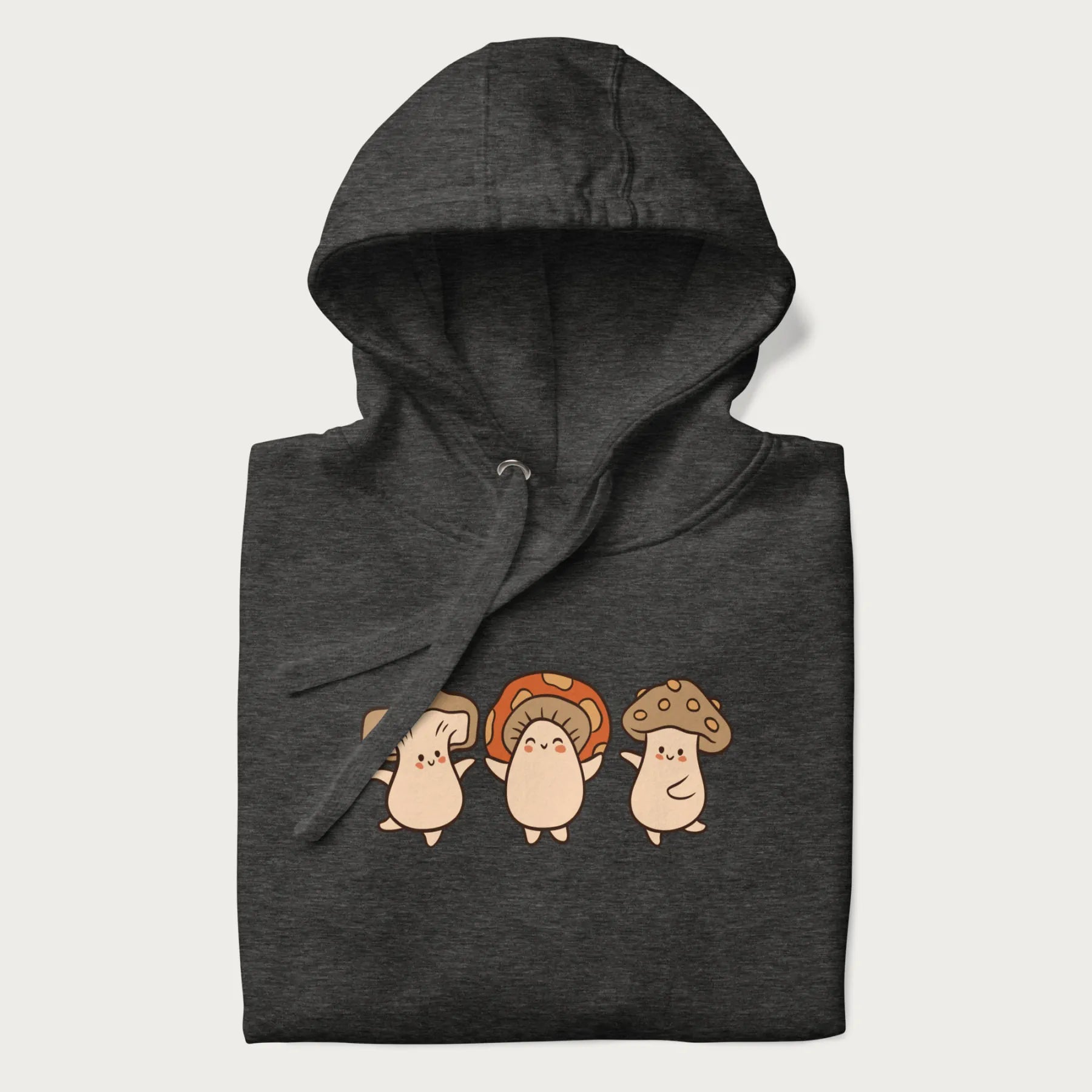 Folded dark grey hoodie with a graphic illustration of three cheerful dancing mushrooms.