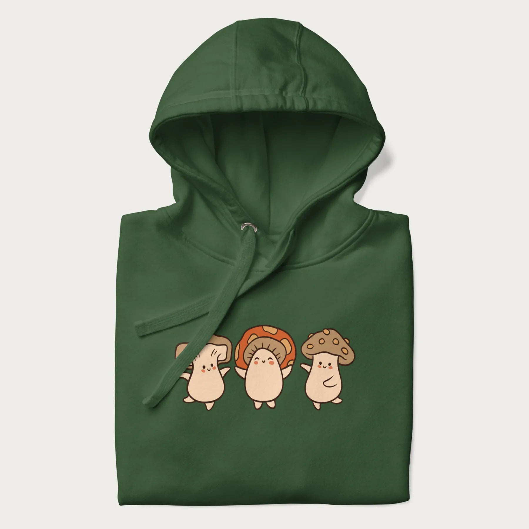 Folded forest green hoodie with a graphic illustration of three cheerful dancing mushrooms.