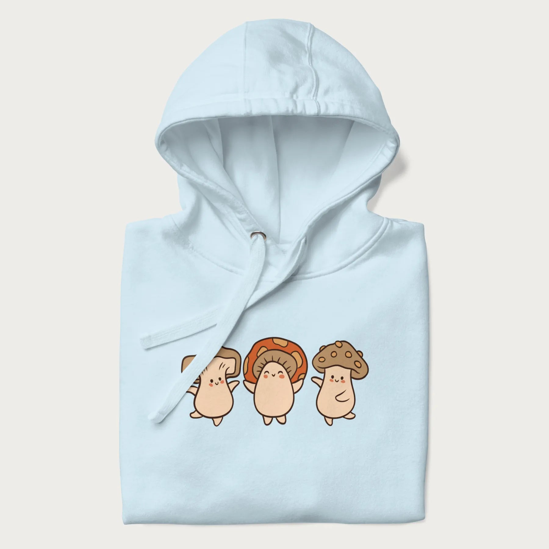 Folded light blue hoodie with a graphic illustration of three cheerful dancing mushrooms.