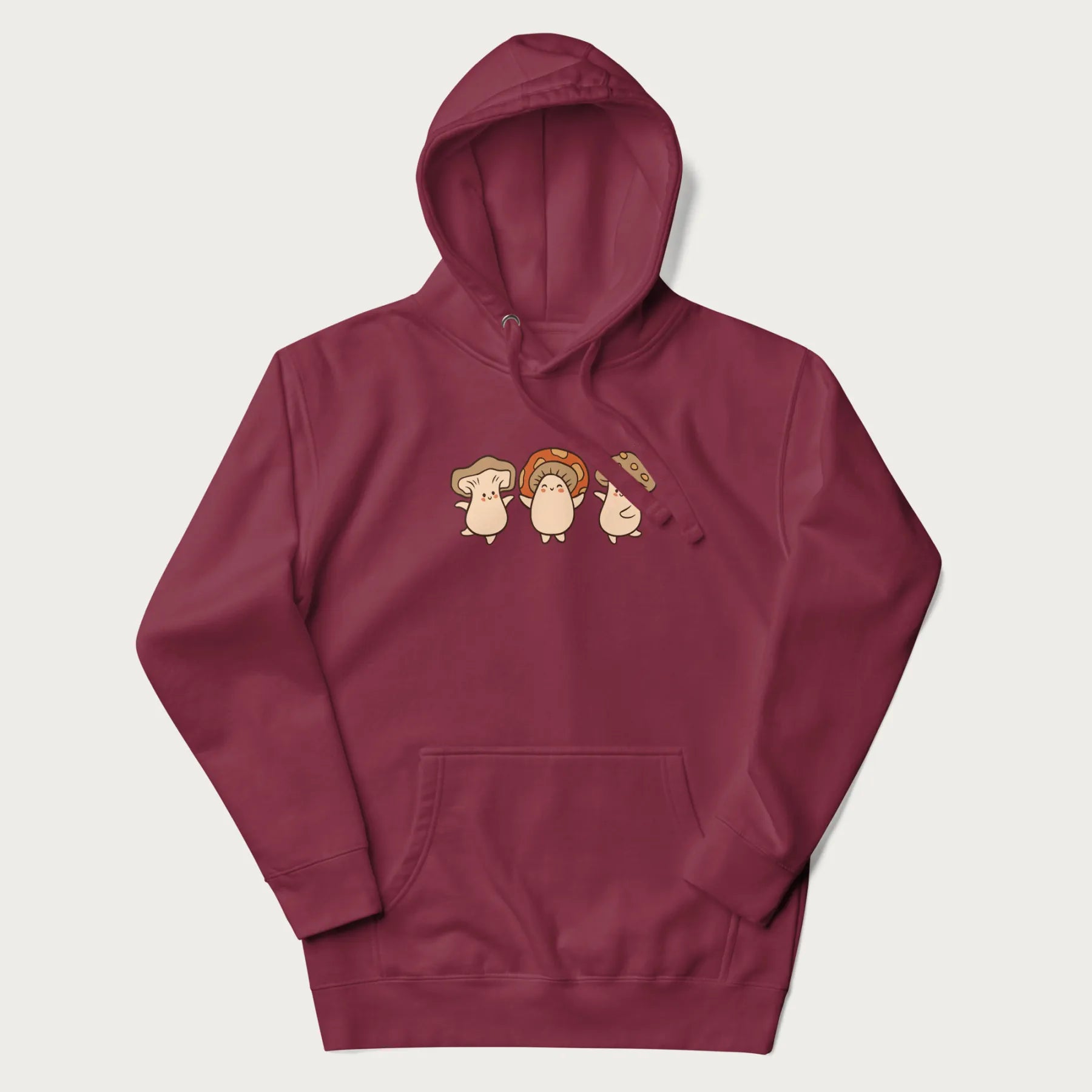 Maroon hoodie with a graphic illustration of three cheerful dancing mushrooms.