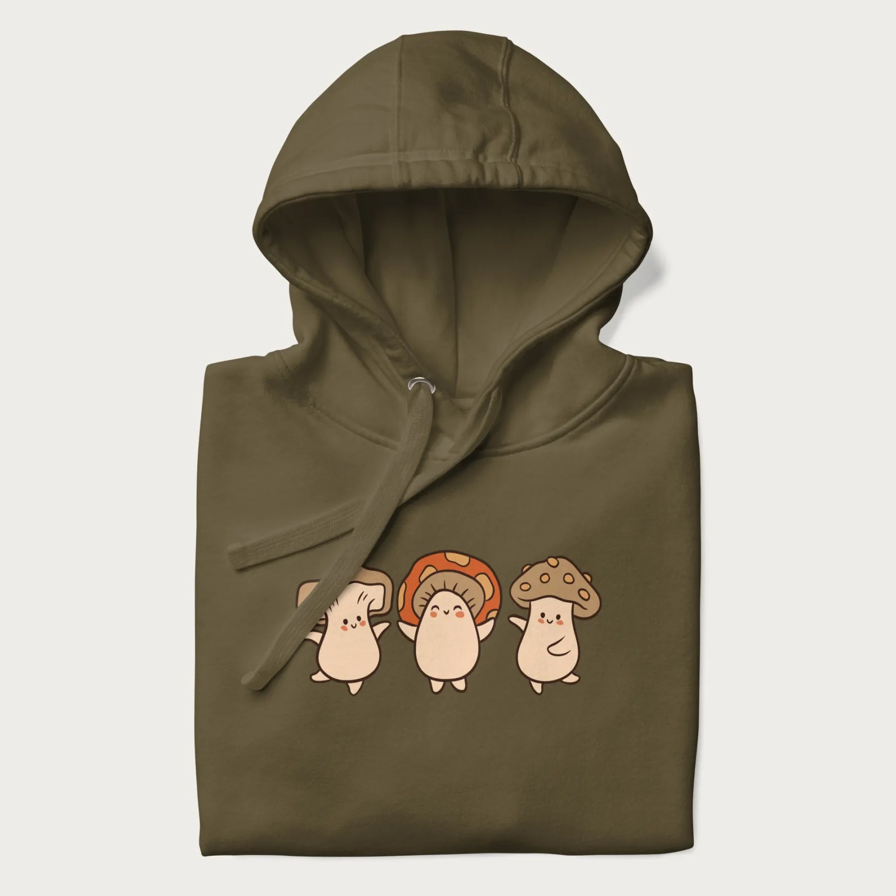Folded military green hoodie with a graphic illustration of three cheerful dancing mushrooms.