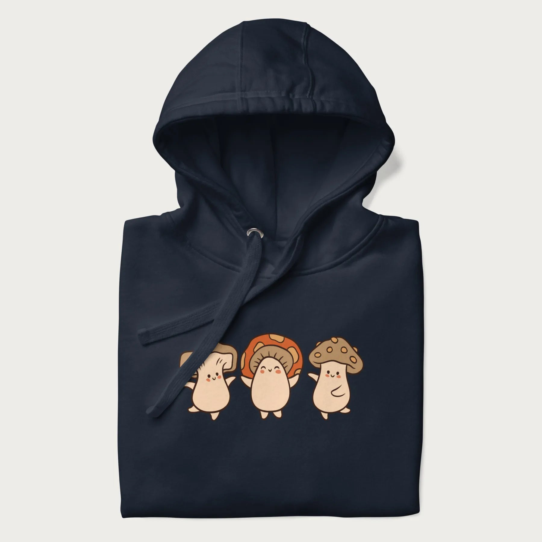 Folded navy blue hoodie with a graphic illustration of three cheerful dancing mushrooms.
