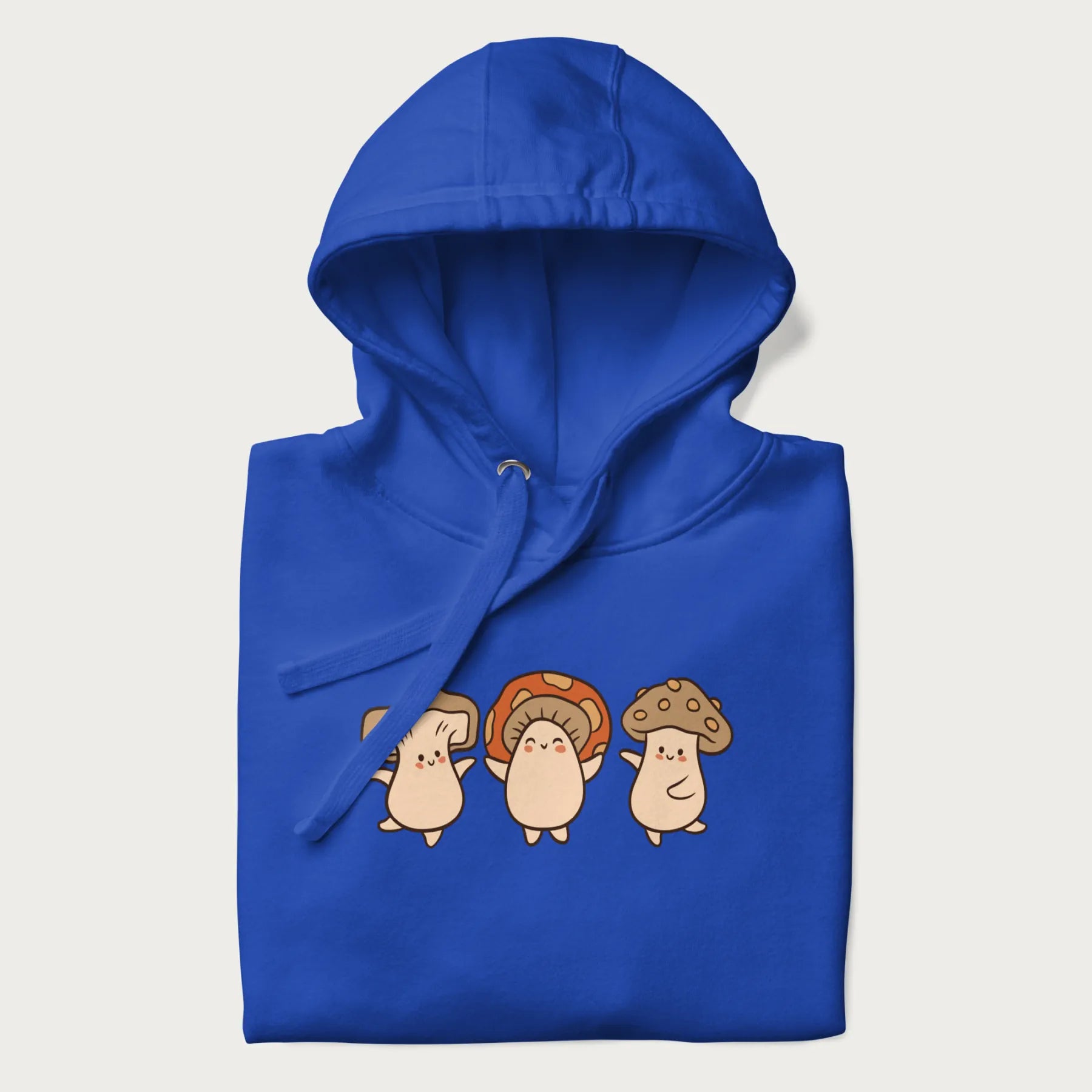 Folded royal blue hoodie with a graphic illustration of three cheerful dancing mushrooms.