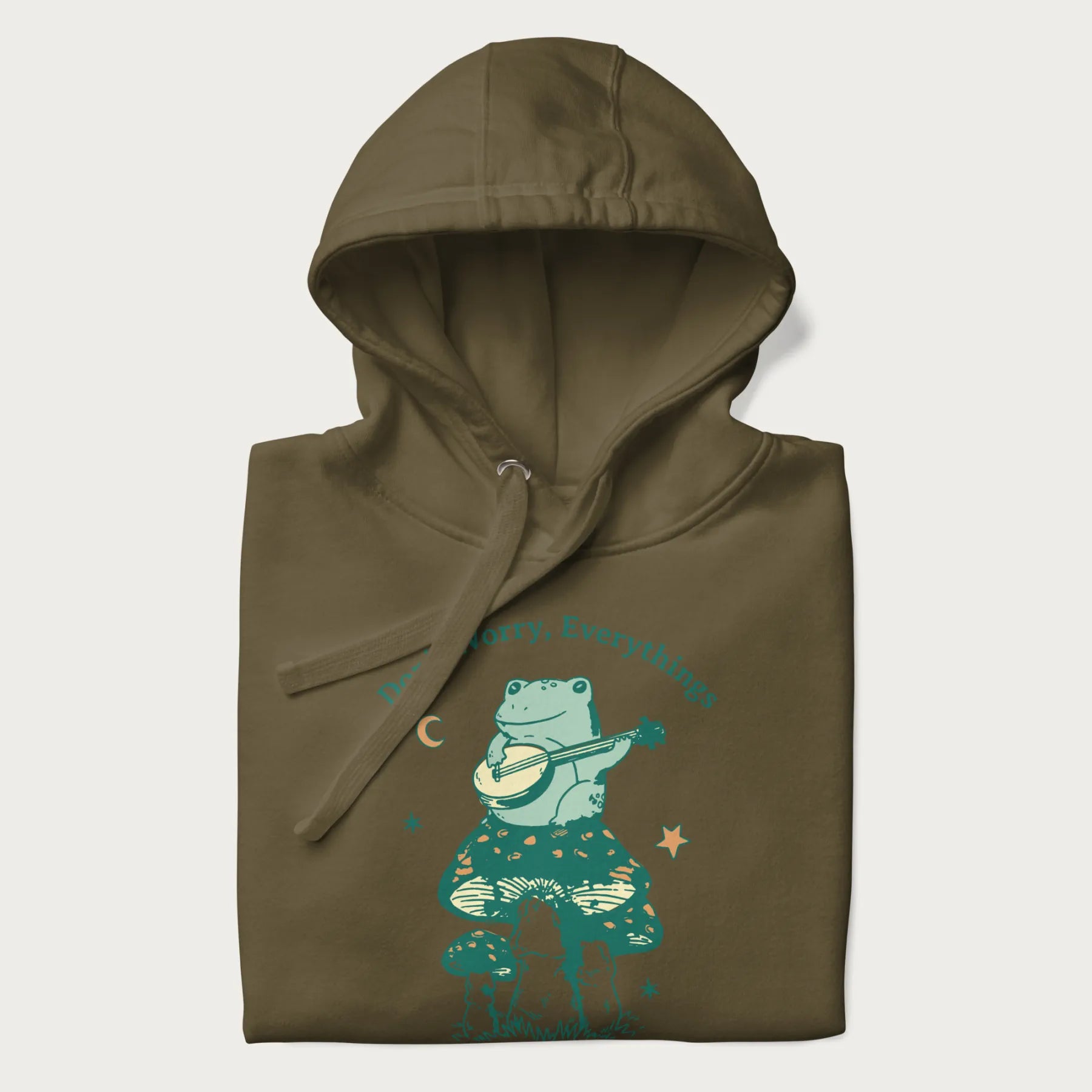 Folded military green hoodie with a graphic of a frog playing a banjo on a mushroom under the moon and stars, with the text 'Don't Worry, Everything's Gonna Be Just Fine.'