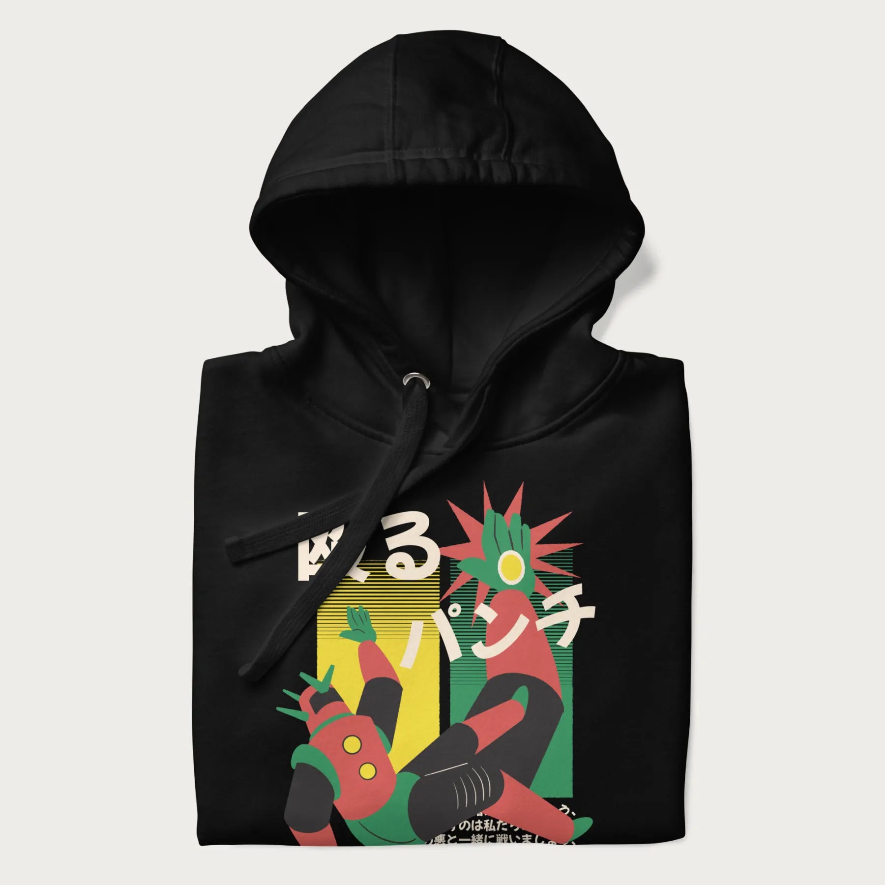 Folded black hoodie with Japanese graphic of a mech warrior in mid-battle, highlighted by Japanese text and dynamic retro color palette.