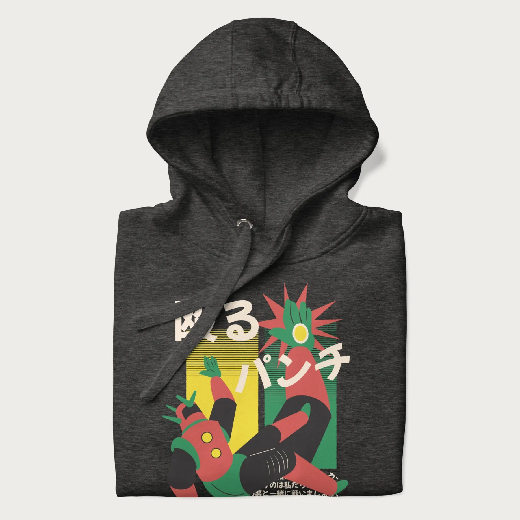 Folded dark grey hoodie with Japanese graphic of a mech warrior in mid-battle, highlighted by Japanese text and dynamic retro color palette.