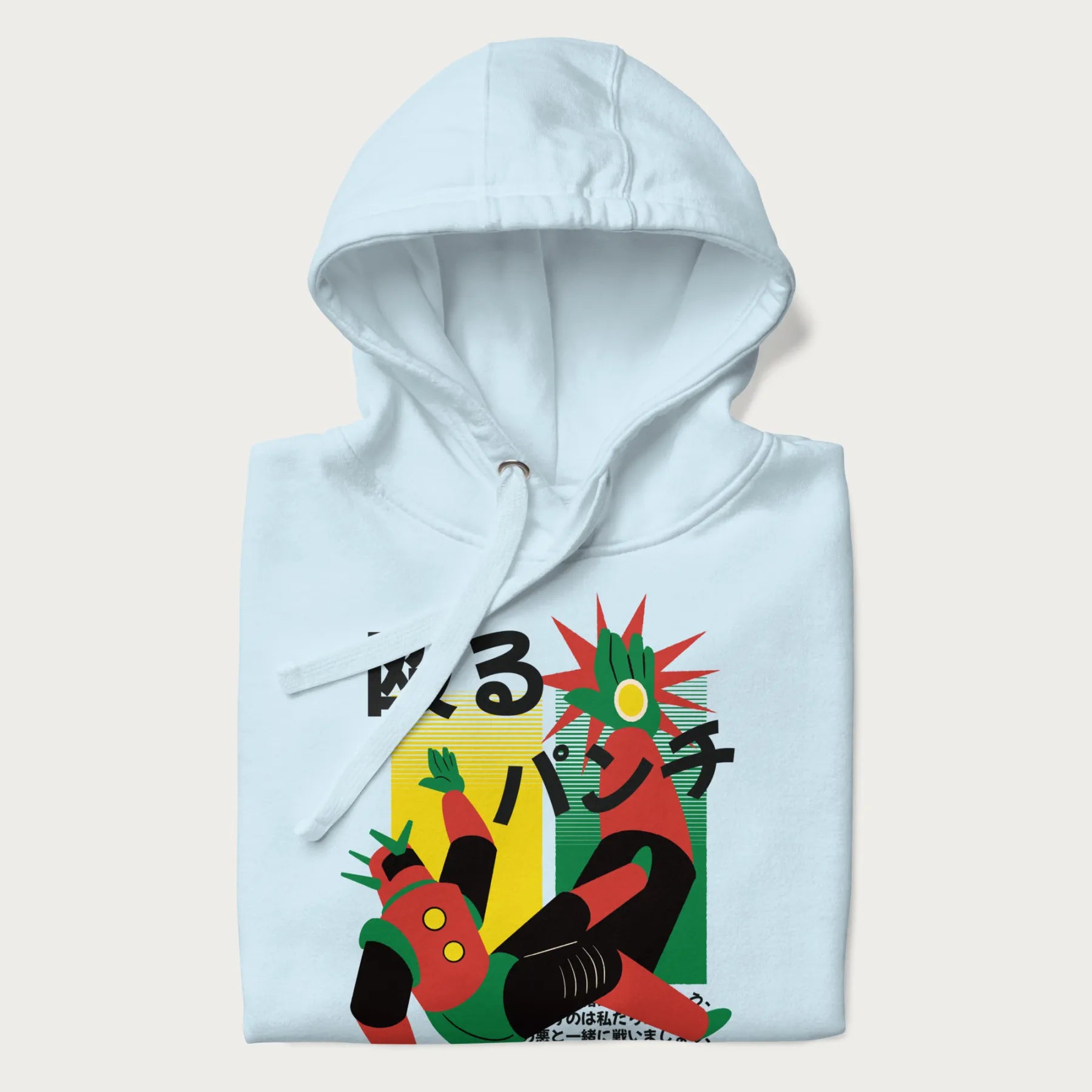 Folded light blue hoodie with Japanese graphic of a mech warrior in mid-battle, highlighted by Japanese text and dynamic retro color palette.