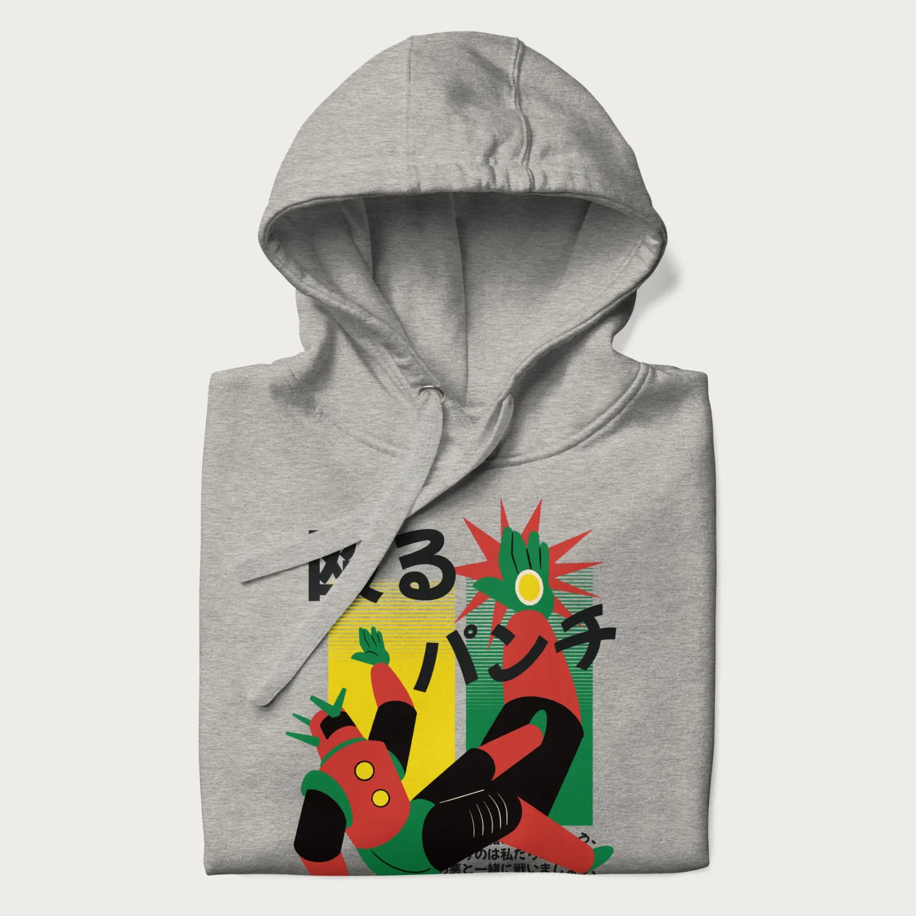 Folded light grey hoodie with Japanese graphic of a mech warrior in mid-battle, highlighted by Japanese text and dynamic retro color palette.