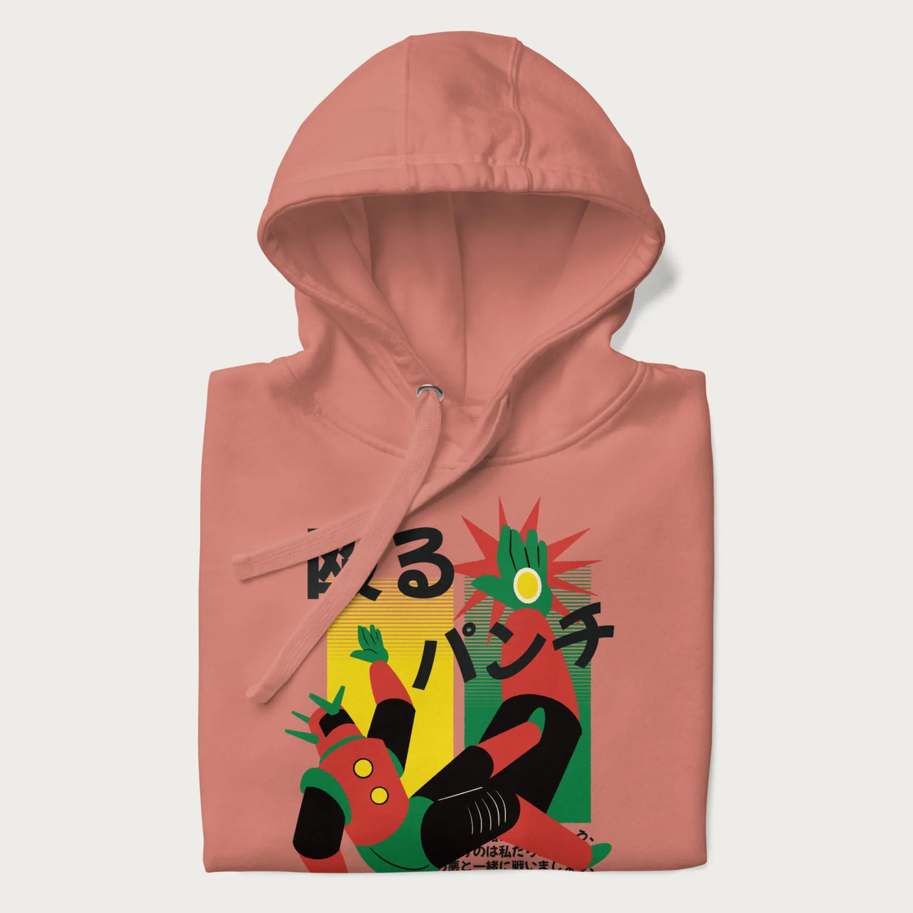 Folded light pink hoodie with Japanese graphic of a mech warrior in mid-battle, highlighted by Japanese text and dynamic retro color palette.