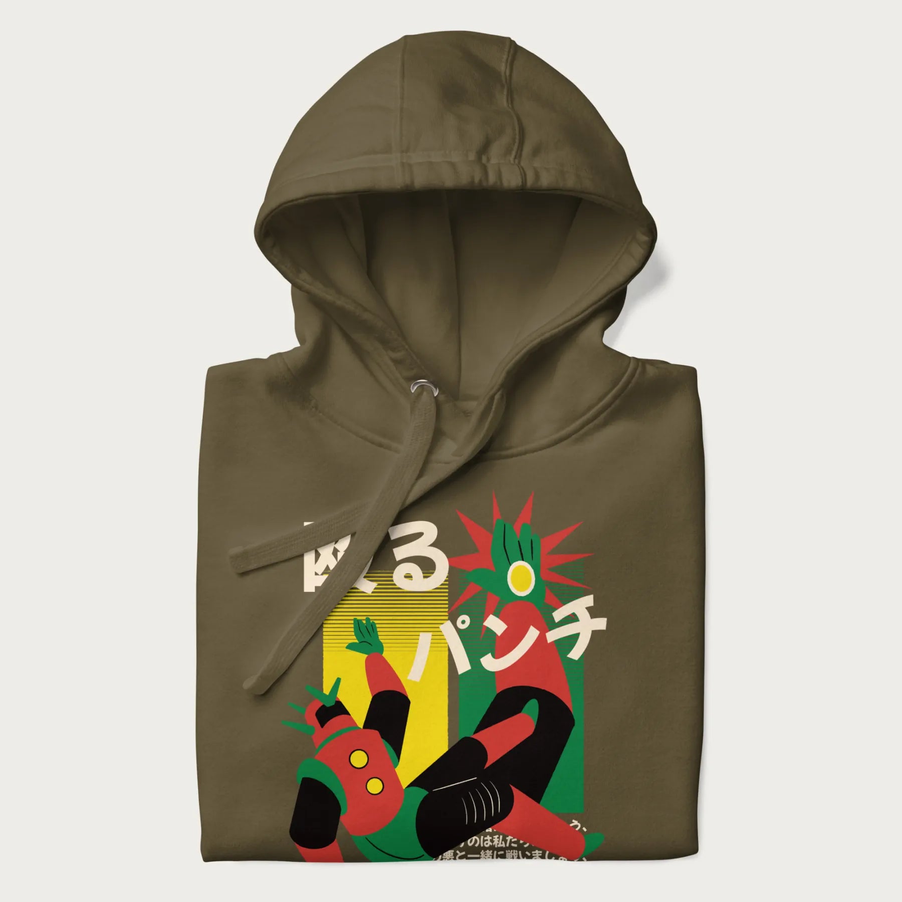 Folded military green hoodie with Japanese graphic of a mech warrior in mid-battle, highlighted by Japanese text and dynamic retro color palette.