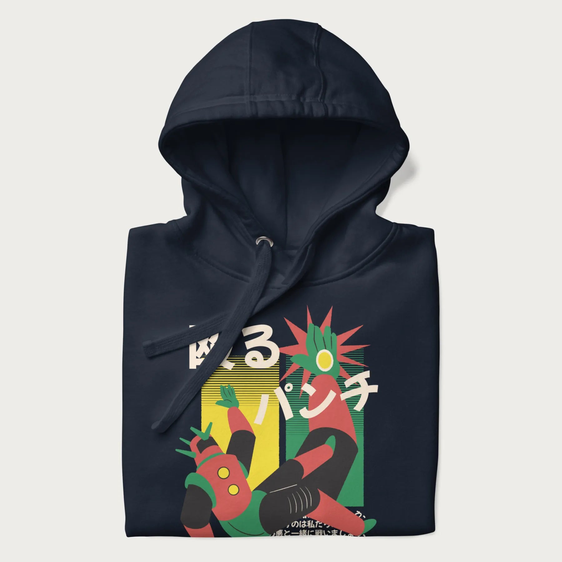 Folded navy blue hoodie with Japanese graphic of a mech warrior in mid-battle, highlighted by Japanese text and dynamic retro color palette.