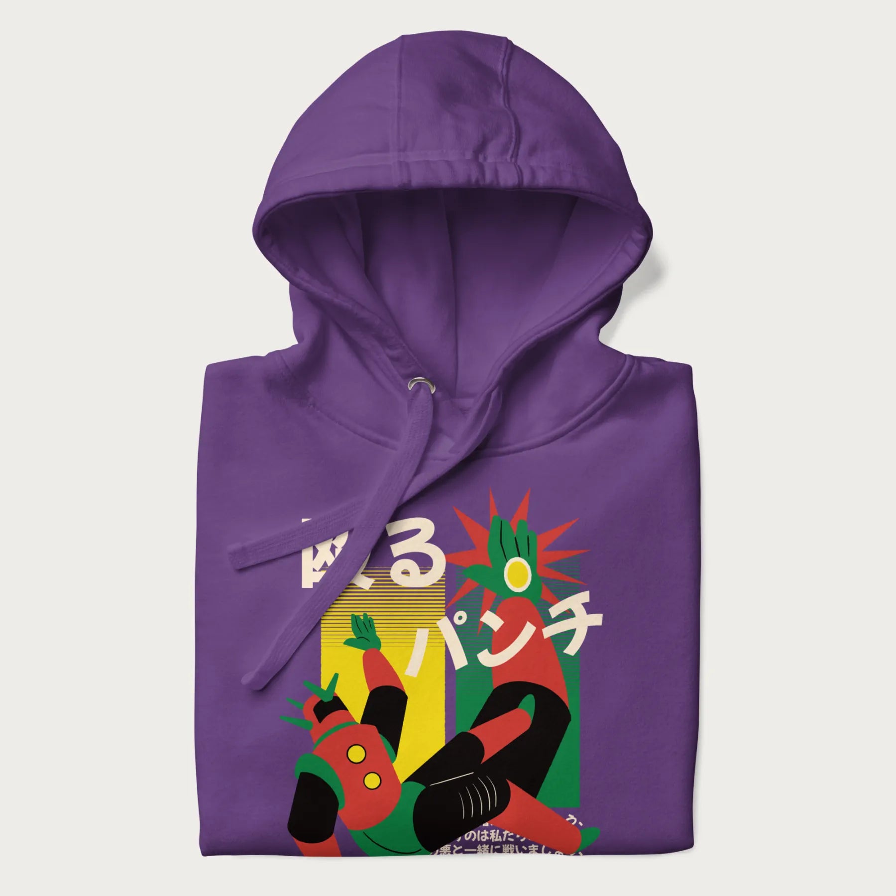 Folded purple hoodie with Japanese graphic of a mech warrior in mid-battle, highlighted by Japanese text and dynamic retro color palette.