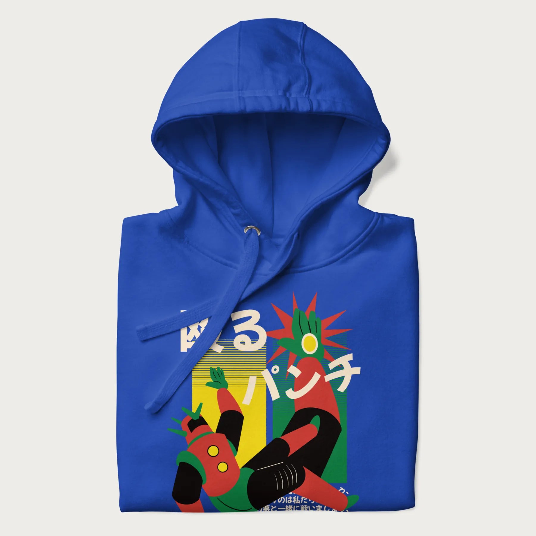 Folded royal blue hoodie with Japanese graphic of a mech warrior in mid-battle, highlighted by Japanese text and dynamic retro color palette.