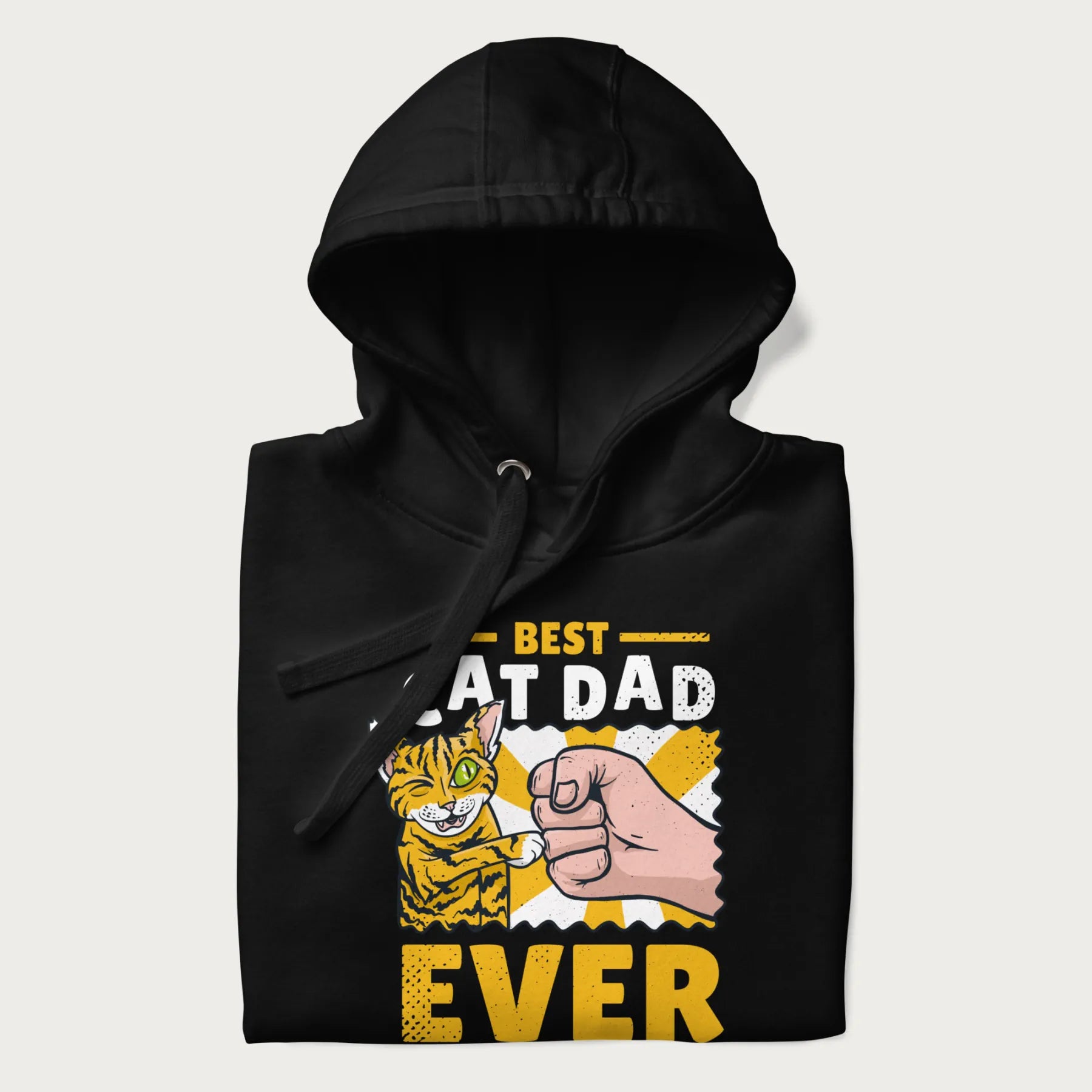 Folded black hoodie with a graphic of a tabby cat and a human fist bumping, with 'Best Cat Dad Ever' in bold letters.