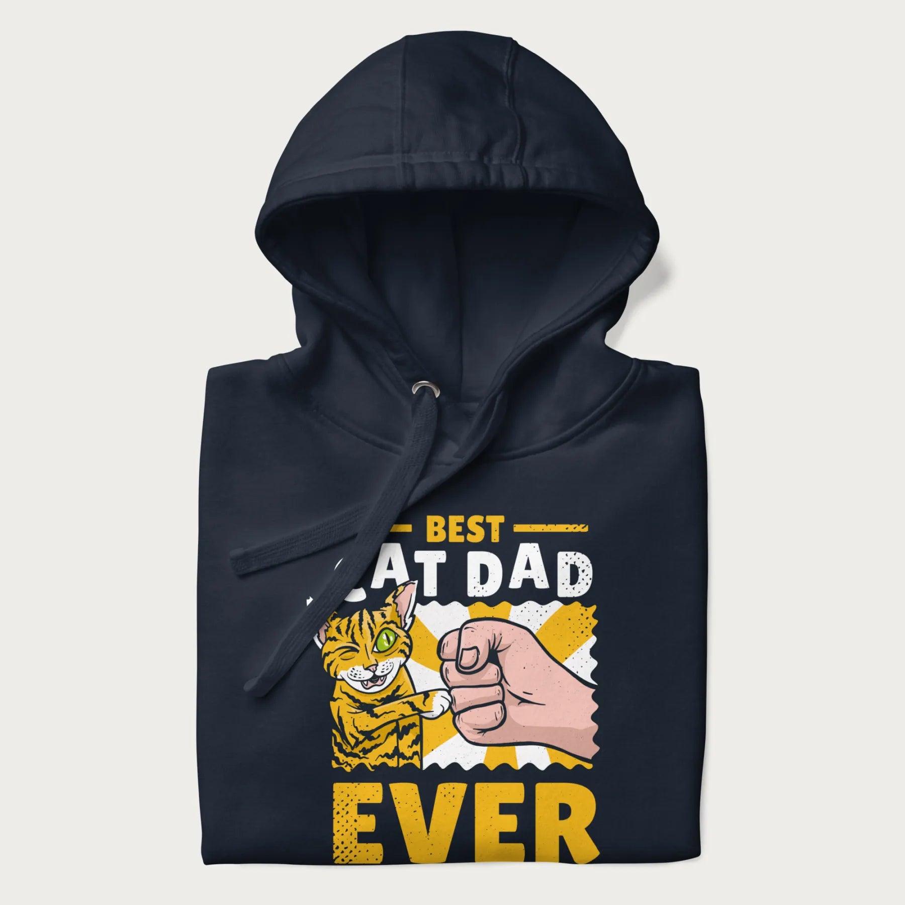 Folded navy blue hoodie with a graphic of a tabby cat and a human fist bumping, with 'Best Cat Dad Ever' in bold letters.