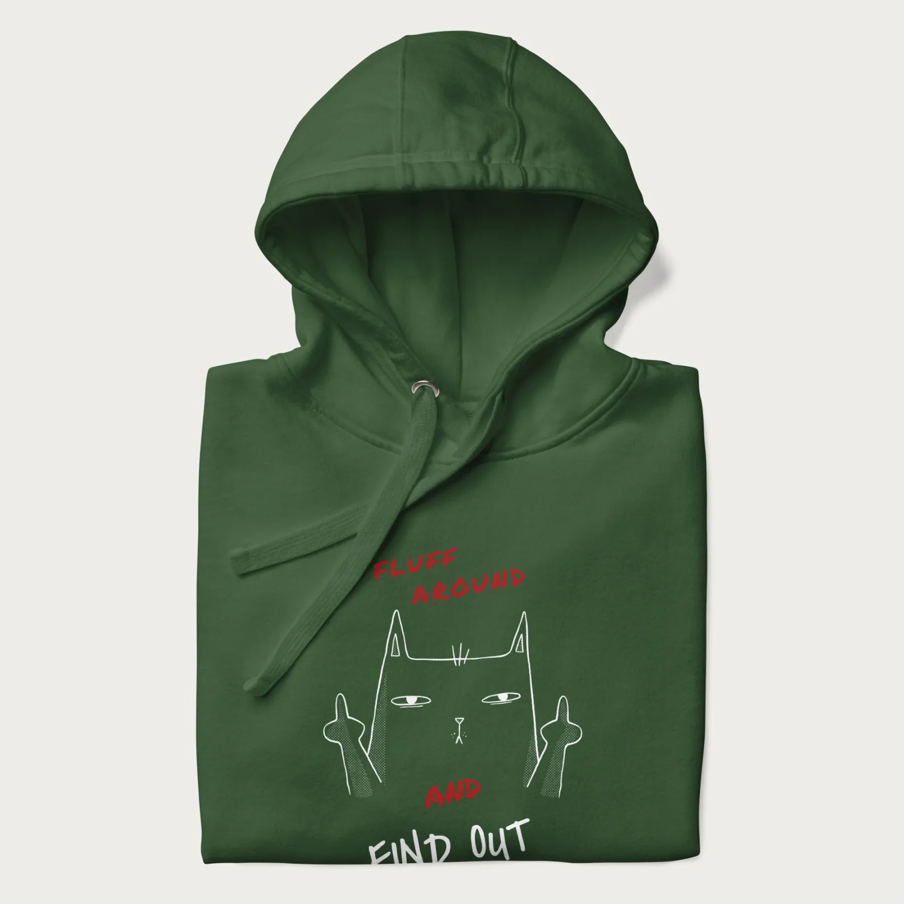 Folded forest green hoodie with a graphic of a cat raising its middle fingers and the text "FLUFF AROUND AND FIND OUT" in red.