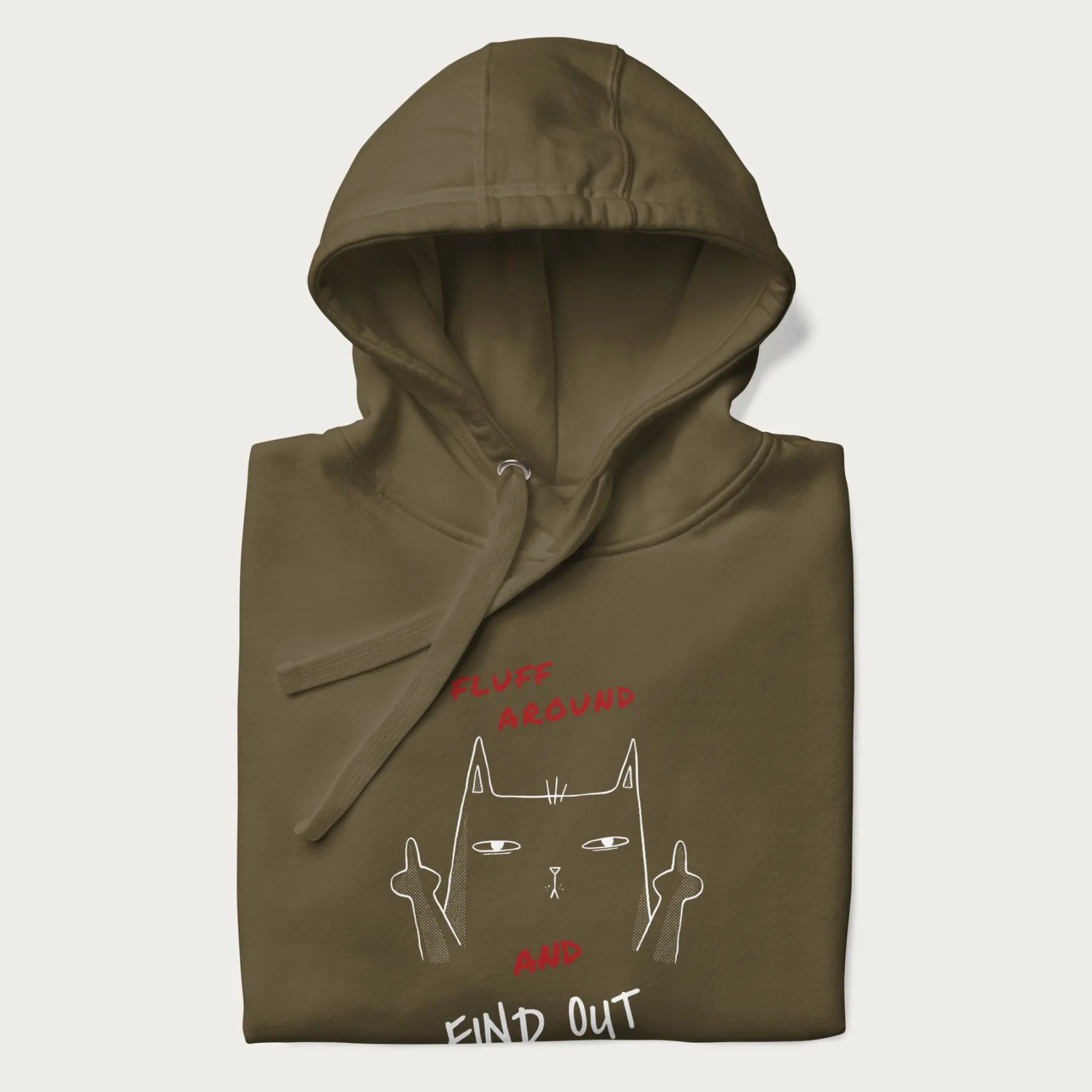 Folded military green hoodie with a graphic of a cat raising its middle fingers and the text "FLUFF AROUND AND FIND OUT" in red.