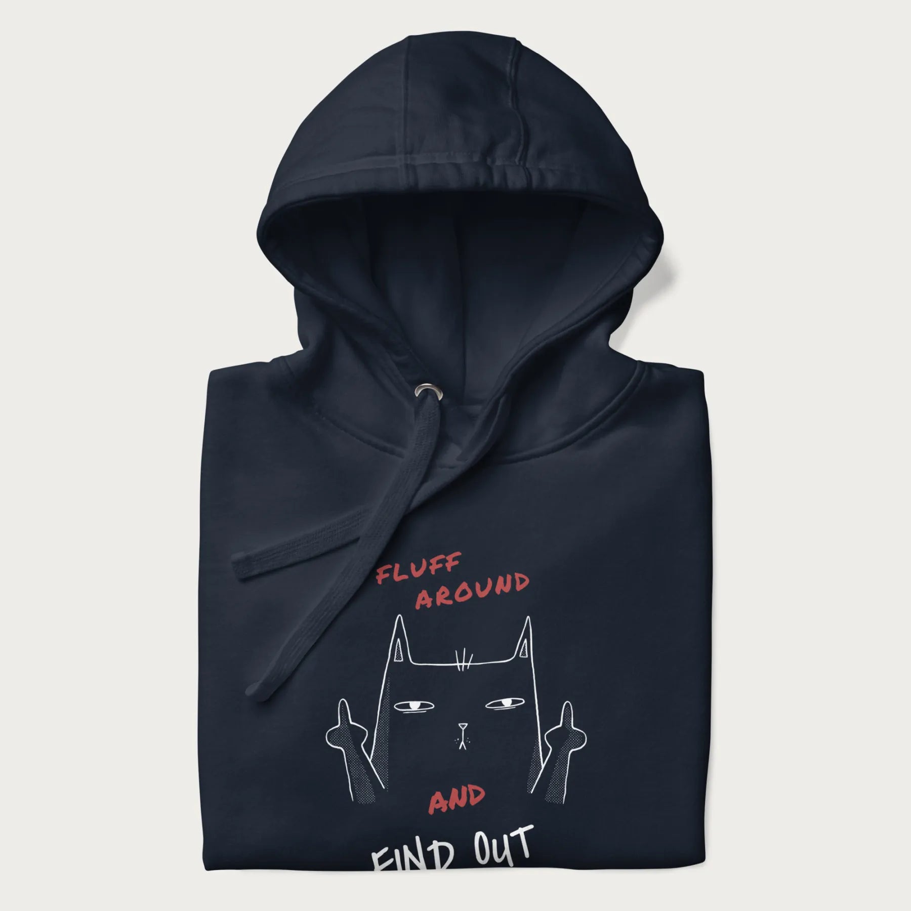 Folded navy blue hoodie with a graphic of a cat raising its middle fingers and the text "FLUFF AROUND AND FIND OUT" in red.