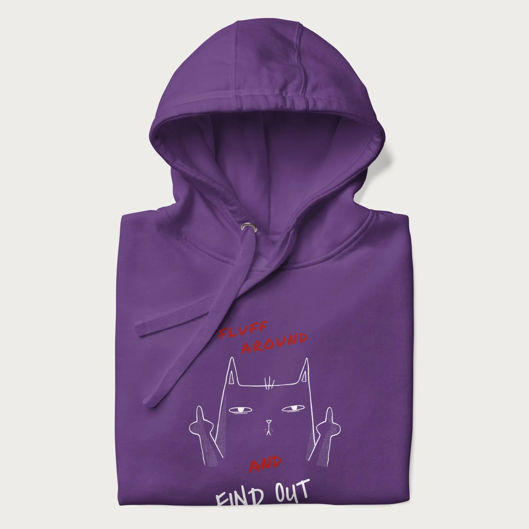 Folded purple hoodie with a graphic of a cat raising its middle fingers and the text "FLUFF AROUND AND FIND OUT" in red.